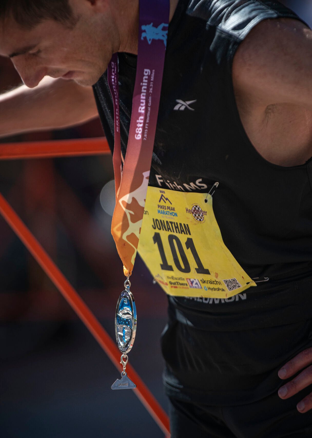 Pikes Peak Marathon 2022 and 2023 winner Jonathan Aziz takes a breath before being interviewed by the announcer in Manitou Springs on Sunday.