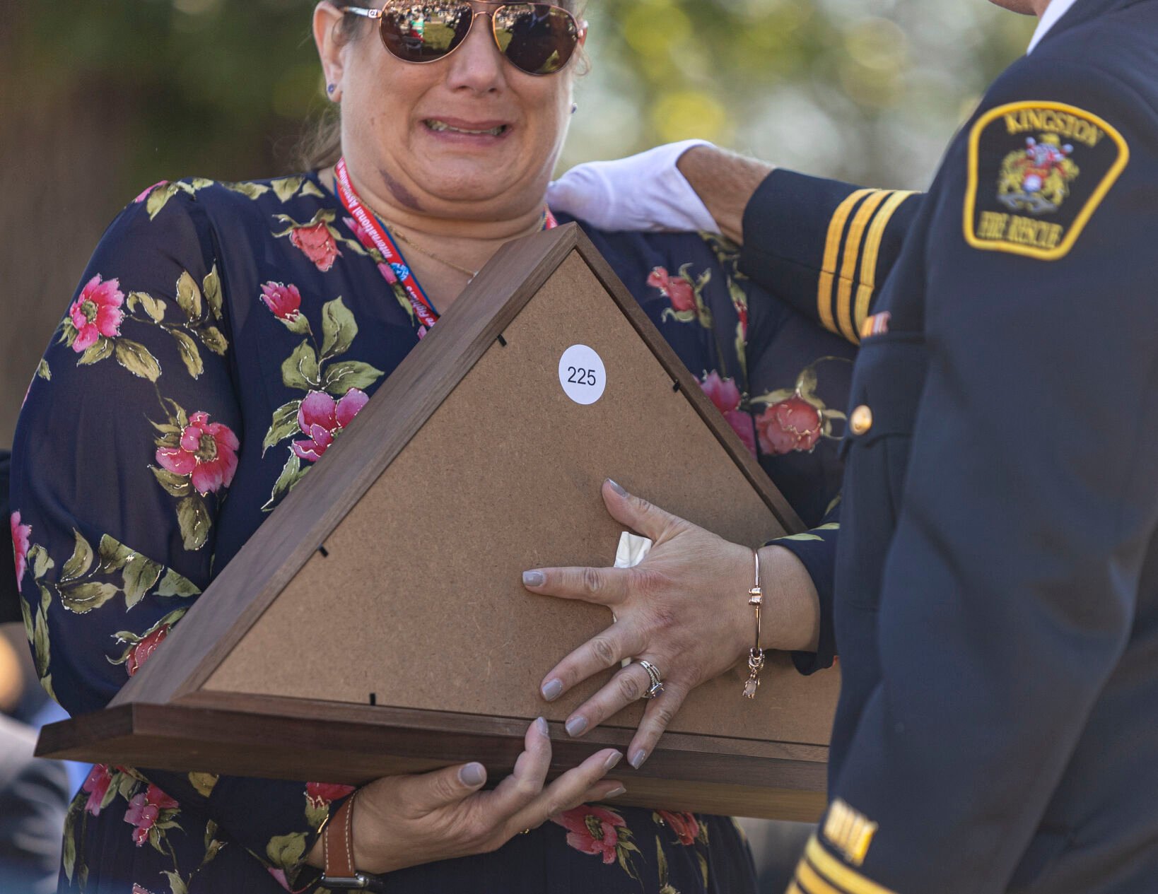 FAR LEFT: Nicole Harris remembers her father George Harris during the Fallen Fire Fighter Memorial 2023 Observance in Memorial Park on Saturday. (Gabi Broekema)