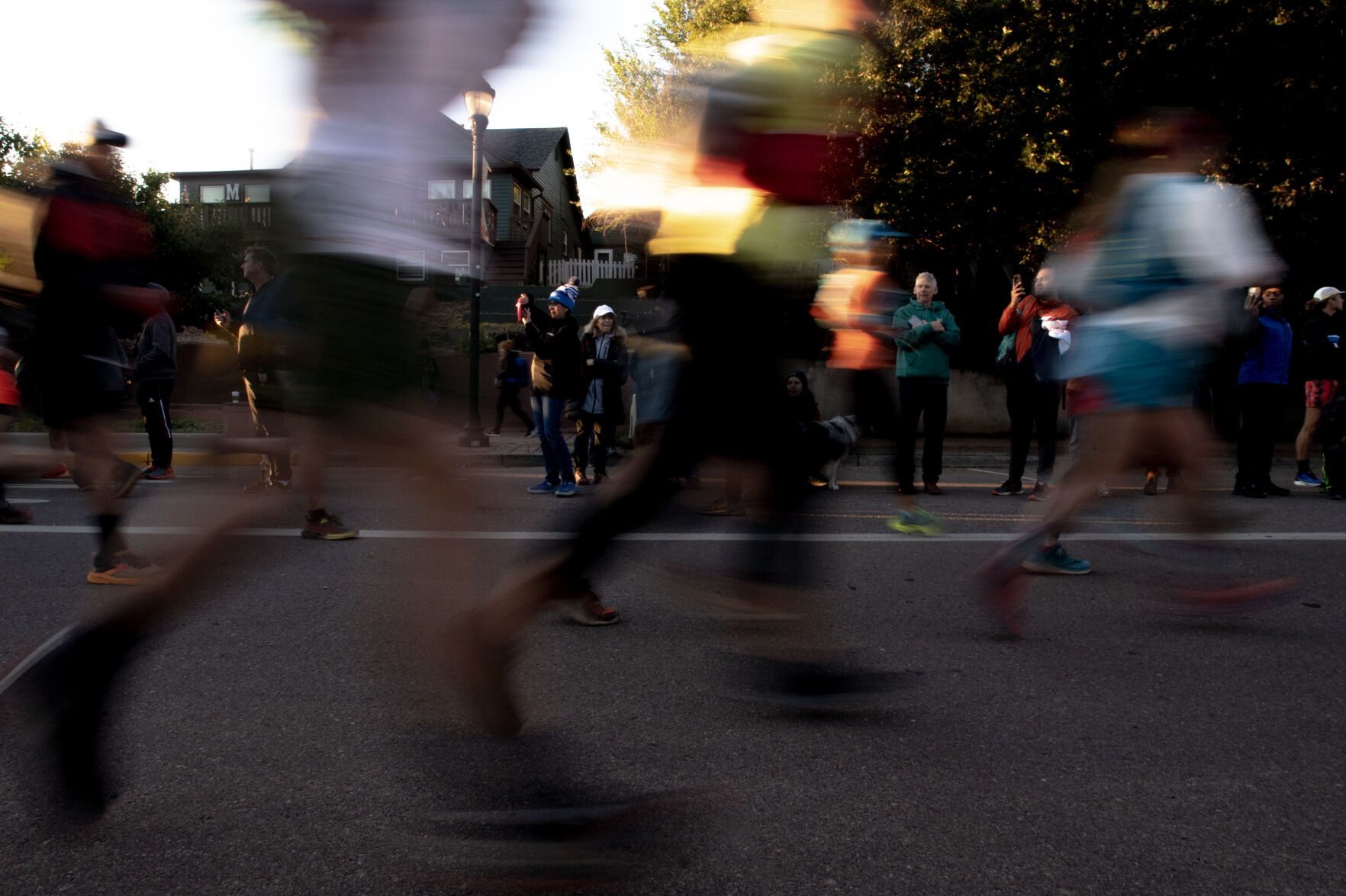Spectators are framed by runners as they take off from the starting line of the Pikes Peak Ascent on Saturday, Sept. 16, 2023. (Parker Seibold, The Gazette) (Parker Seibold)