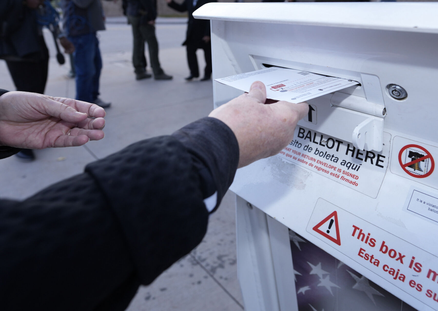 A voter places a ballot in a drop box outside the Denver Elections Division headquarters on Nov. 8, 2022, in downtown Denver, in this file photo. ((AP Photo/David Zalubowski, File))