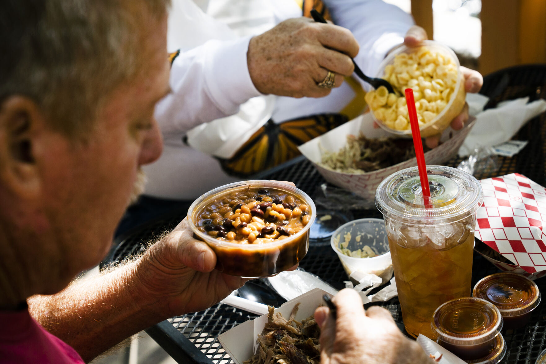 Jim Mundorf helps himself to a serving of beans while his wife, Nancy, plates some macaroni and cheese on Friday, September 24, 2021 at Switchback Smokehouse in Kittredge, Colorado. The couple was visiting from North Carolina. (Photo by Katie Klann/The Gazette) (Katie Klann The Gazette)