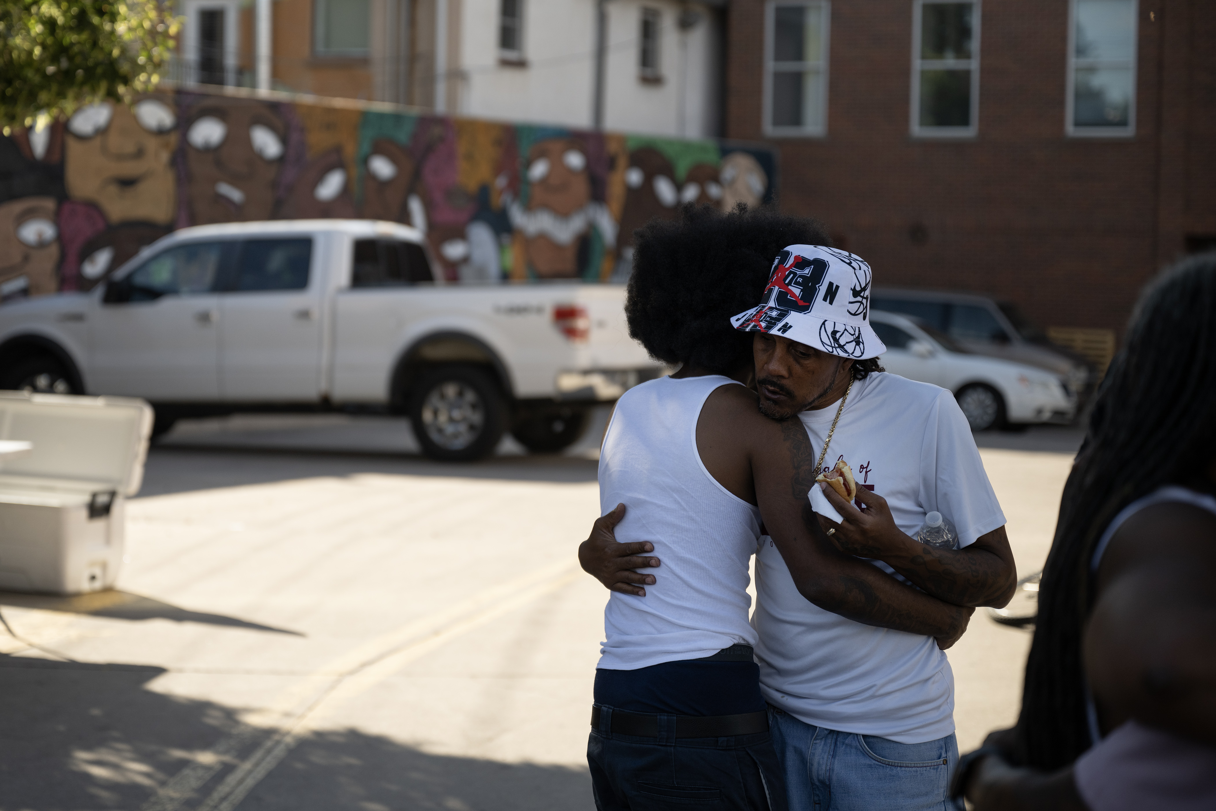 Struggle of Love Foundation founder and program director Joel Hodge, right, hugs Qtee as he arrives during a “Safe Haven Activation” in response to a shooting double-homicide on Aug. 19 as seen on Thursday, Aug. 31, 2023, at Five Points Plaza in Denver. (Timothy Hurst/Denver Gazette) (TimHursttim.hurst@gazette.comhttps://secure.gravatar.com/avatar/aca82bd62b4ee425c598527cd6faa1b1?d=mm&r=g)