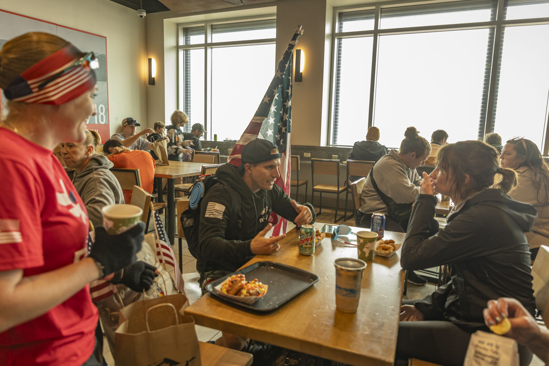 With only white haze to enjoy for a view, Team RWB members enjoy conversation over the world-renowned high altitude doughnuts of Pike Peak Summit Visitor Center before heading down back down to Manitou Springs by car or Cog-Way. (Gabi Broekema)