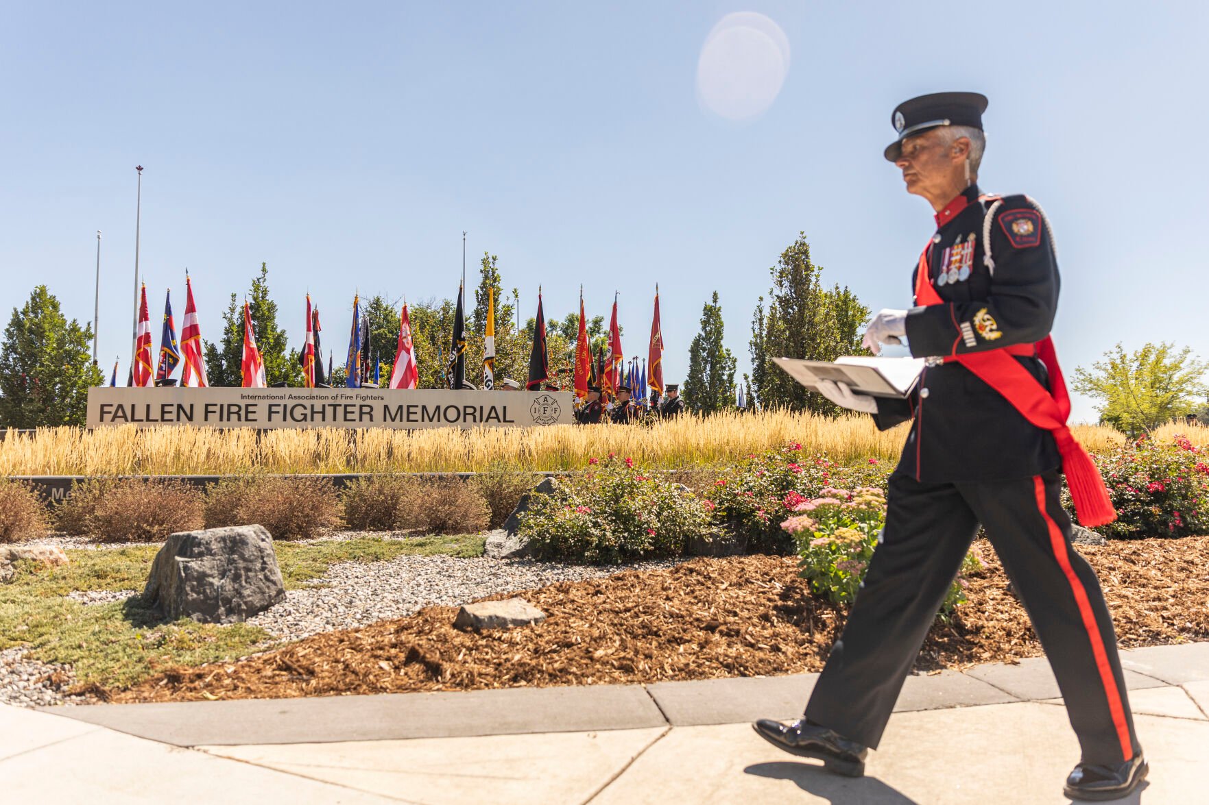 ABOVE AND LEFT: Families, friends and fellow firefighters respect and remember 572 fallen firefighters during the Fallen Fire Fighter Memorial 2023 Observance in Memorial Park on Saturday. (Gabi Broekema)