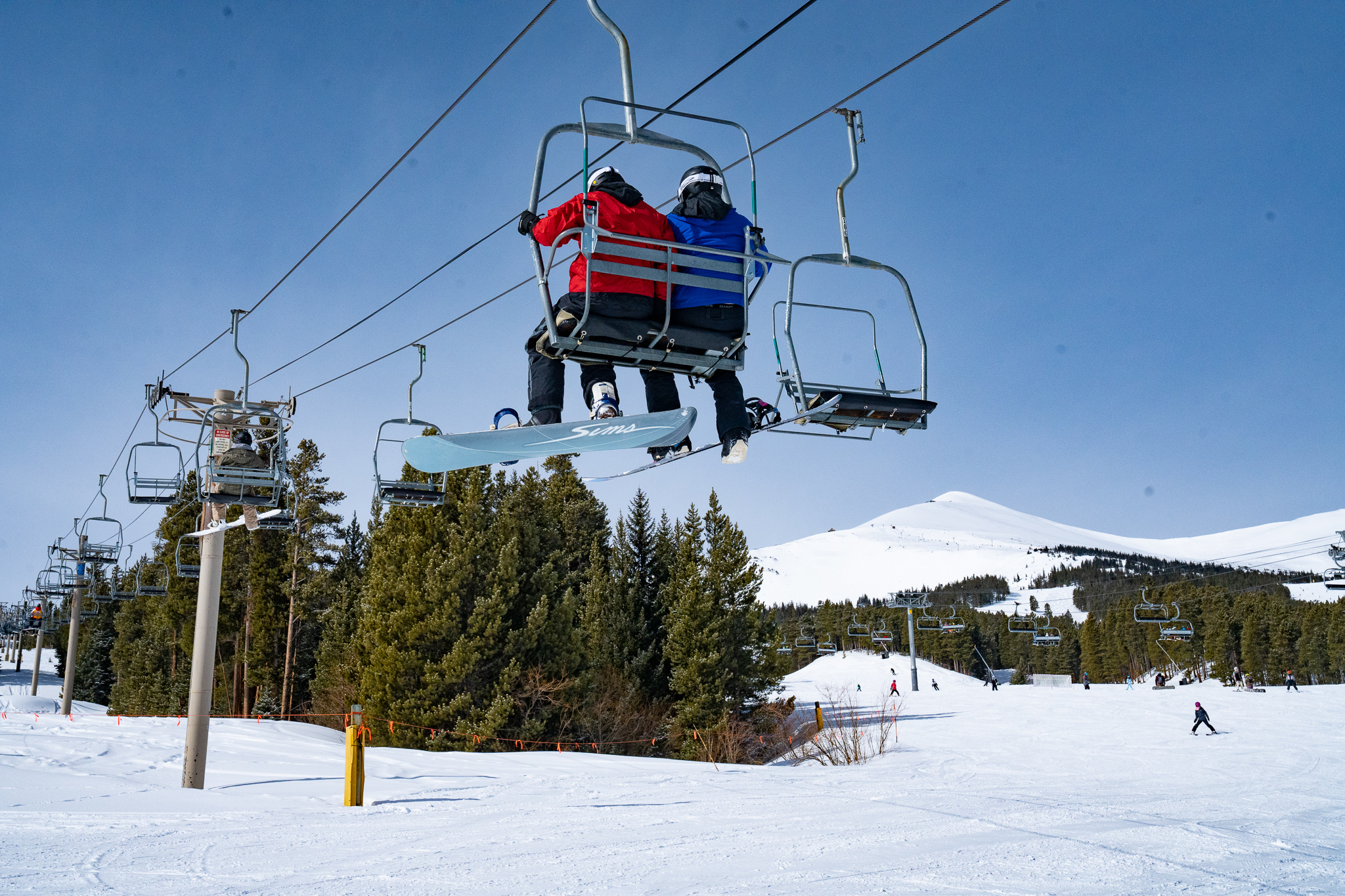 Skiers and riders sit on the 5-Chair at Breckenridge Ski Resort near the Peak 8 base area. The old double-chair is being replaced for the 2023-24 ski season with a high-speed quad chairlift title Five SuperChair. The chairs are being auctioned off for charity. (Courtesy: Breckenridge Ski Resort)