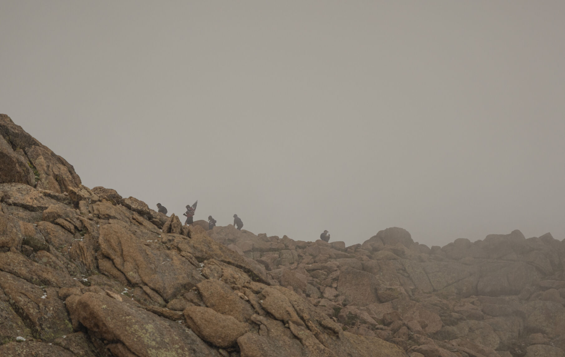 Team Red, White & Blue members summit on Pikes Peak through the haze of a snowstorm on Sunday, September 10, 2023. (Gabi Broekema)