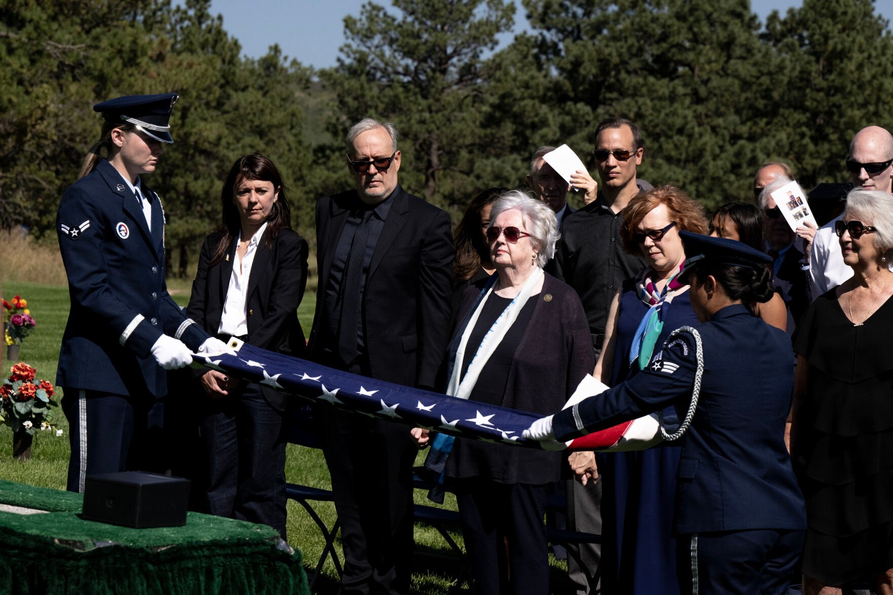 An American Flag is unfolded in front of retired Air Force Col. Karol Bobko’s family during his funeral at the United States Air Force Academy Cemetery on Friday, Sept. 8, 2023. Bobko, a member of the Academy’s first graduating class in 1959, went on to become the first graduate to serve as a NASA astronaut. Bobko was the astronaut to fly on the maiden voyages of two shuttles: the Challenger and the Atlantis. (Parker Seibold, The Gazette) (Parker Seibold)