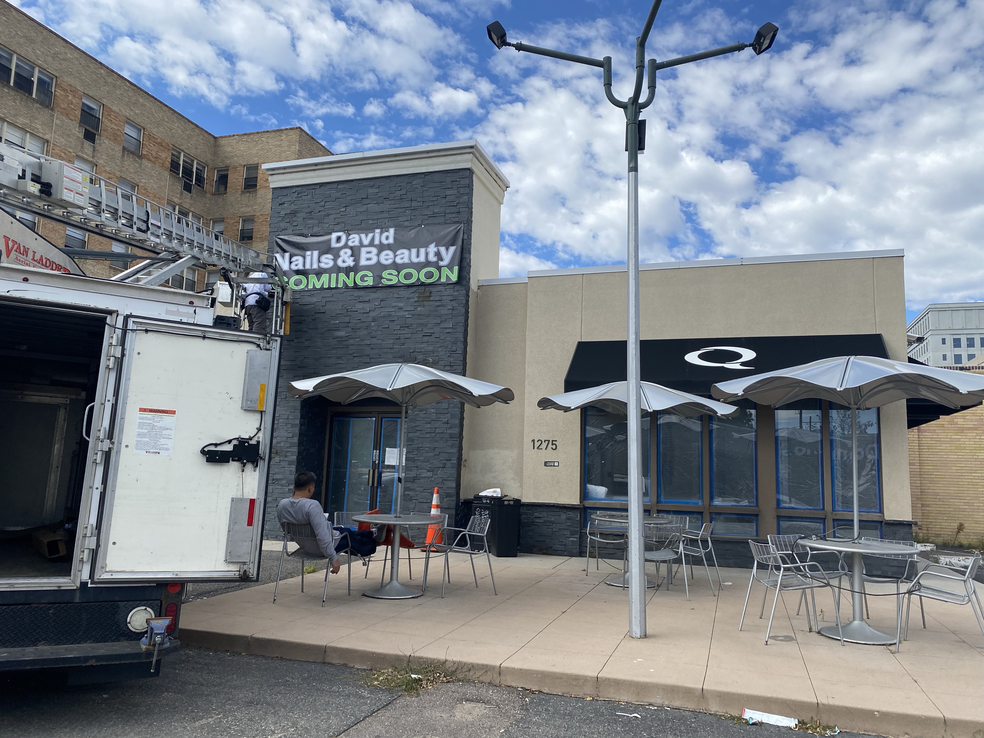 Workers hang a David Nails & Beauty sign at the original Quiznos location at 1275 Grant Street in Denver on Tuesday, September 19, 2023. (Stephen Barr/Denver Gazette)
