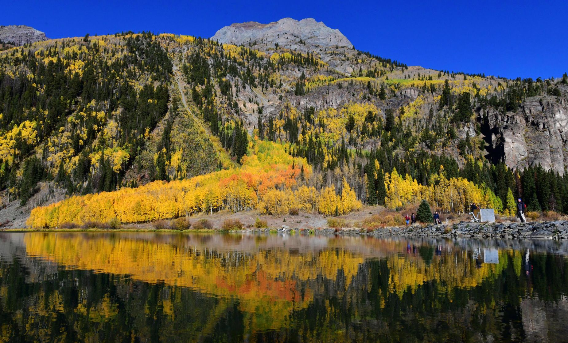 Aspens reflect in the clear waters of Crystal Lake, south of Ouray, Colorado, on Hwy. 550 (also known as the Million Dollar Highway. Wednesday, October 2, 2019. (Photo by Jerilee Bennett, The Gazette)051423-sg-fall-refer-1 (JERILEE BENNETT, THE GAZETTE)