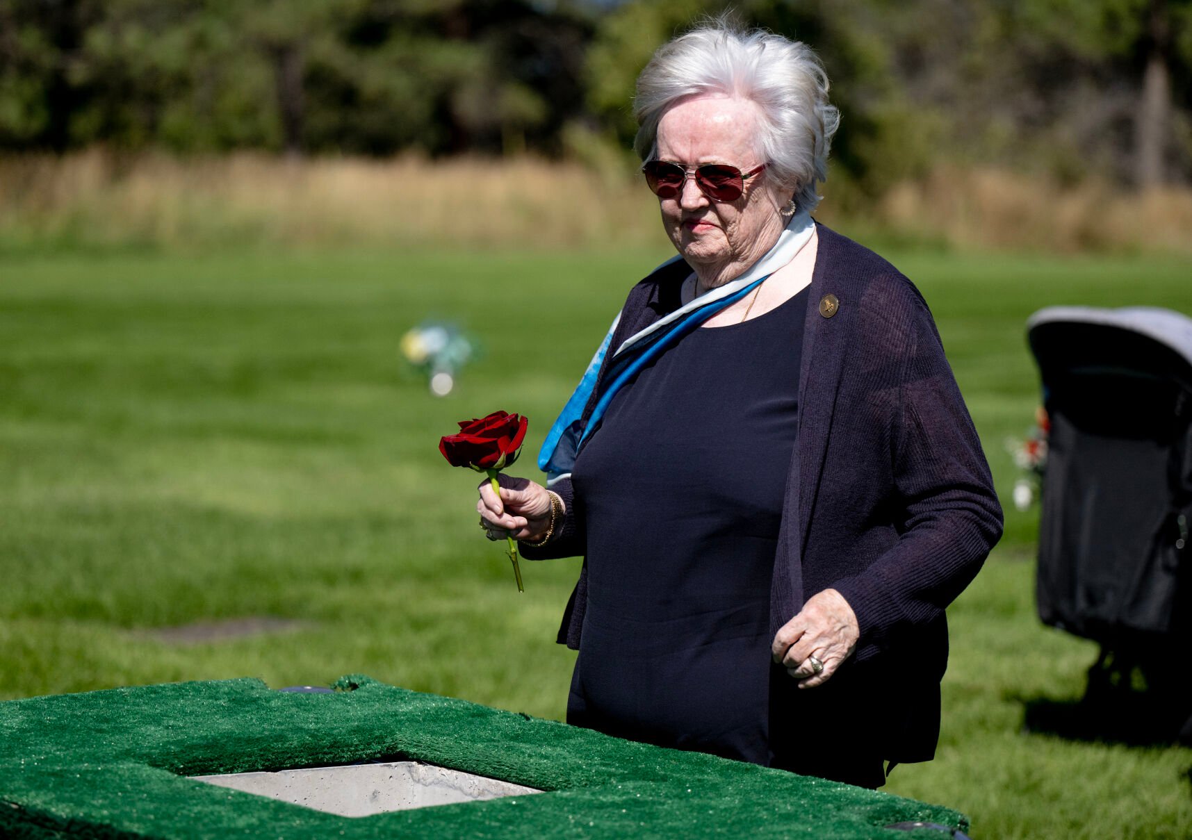 Dianne Bobko, the widow of retired Air Force Col. Karol Bobko, places a rose into his urn vault during a funeral at the United States Air Force Academy Cemetery on Friday, Sept. 8, 2023. (Parker Seibold, The Gazette) (Parker Seibold)