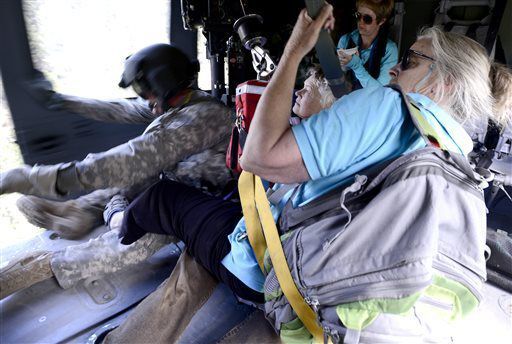 FILE PHOTO: Two women are rescued by a helicopter crew with the 2-4 GSAB 4th Infantry Division based in Ft. Carson near Jamestown, Colo., on Tuesday, Sept. 17, 2013. The Office of Emergency Management says that the weather is expected to be clear enough to allow helicopters to take to the skies to rescue flood victims. (AP Photo/The Daily Camera, Mark Leffingwell, Pool) (AP Photo/The Daily Camera, Mark Leffingwell, Pool)