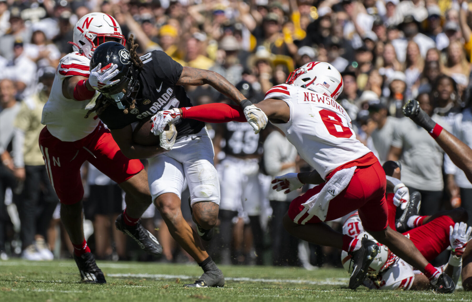 Colorado Buffaloes wide receiver Xavier Weaver (10) runs past Nebraska defensive backs DeShon Singleton (8) and Quinton Newsome for a first down during the second half Saturday, Sept. 9, 2023, at Folsom Field in Boulder, Colo. (The Gazette, Christian Murdock) (Christian Murdock/The Gazette)