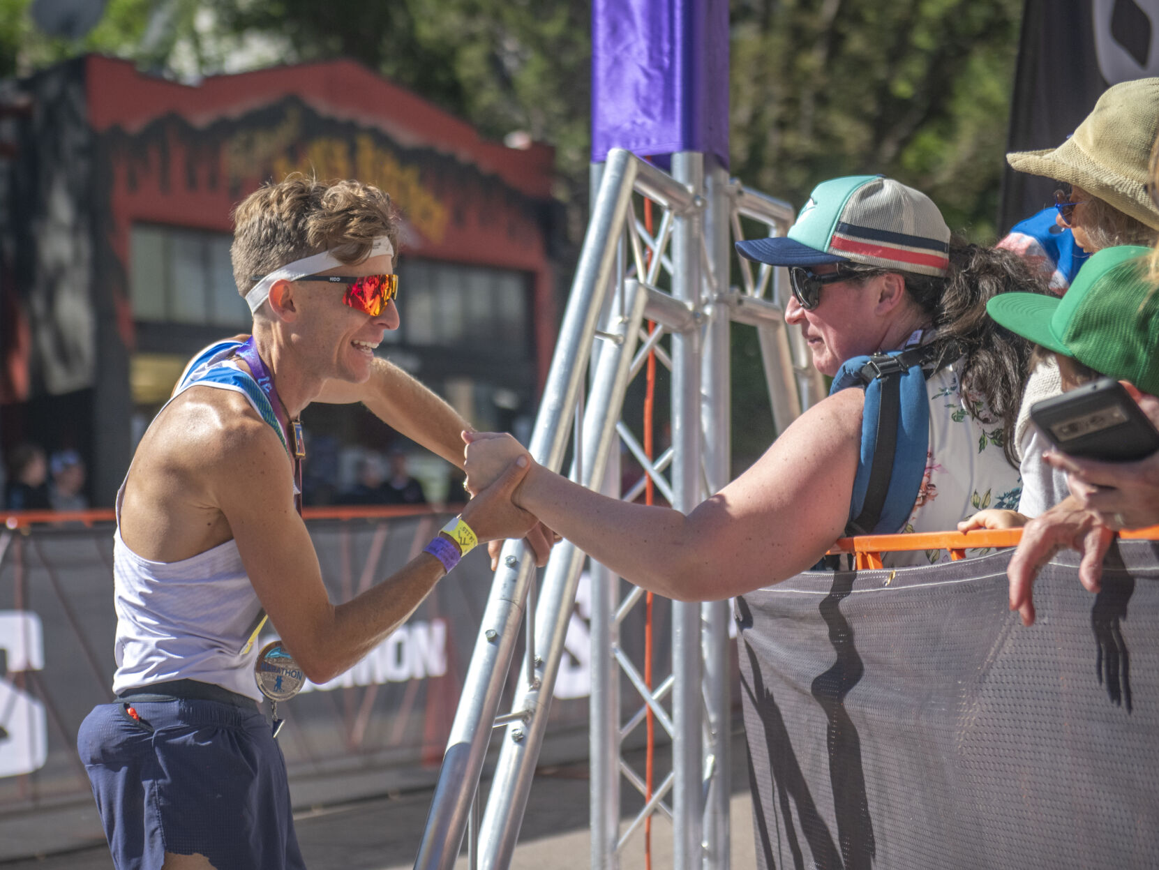 Pikes Peak Marathon 2023 runner-up Seth DeMoor immediately goes to embrace his wife Brigid DeMoor and 6 children after finishing the Pikes Peak Marathon in Manitou Springs on Sunday, September 17, 2023. (Gabi Broekema)