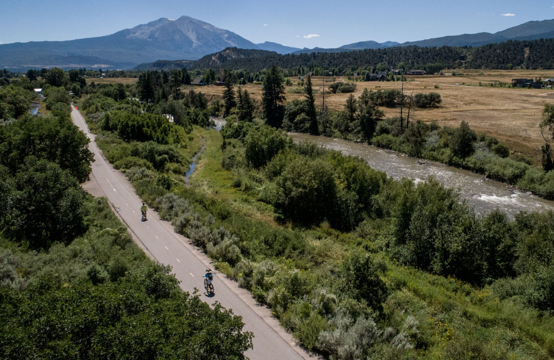 Cyclists ride the Rio Grande Trail with the Roaring Fork River to the west and Mount Sopris to the south near Carbondale last week. (photos by Parker Seibold, the gazette)