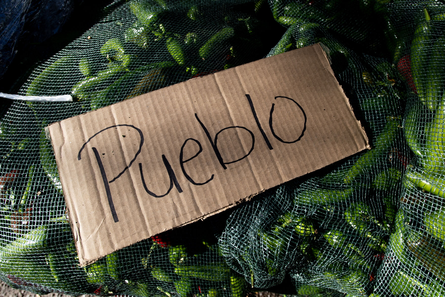 A cardboard sign sits on top of bags of chiles at the 29th Annual Pueblo Chile and Frijoles Festival in Pueblo, Colo., on Friday, Sept. 22, 2023. (Parker Seibold, The Gazette) (Parker Seibold)