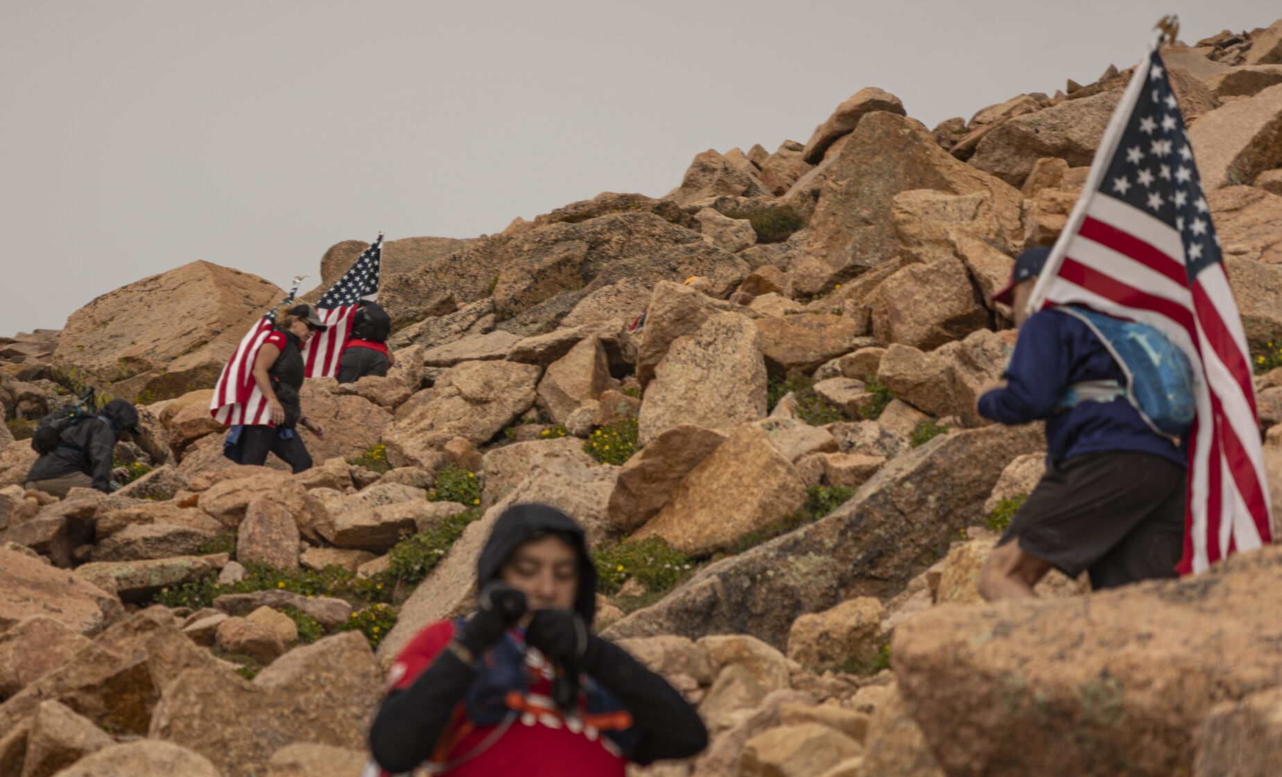 Team RWB quickly starts the final section of the hike to Pikes Peak summit as a snowstorm rolls lover front he west side of the mountain on Sunday, September 10, 2023. (Gabi Broekema)