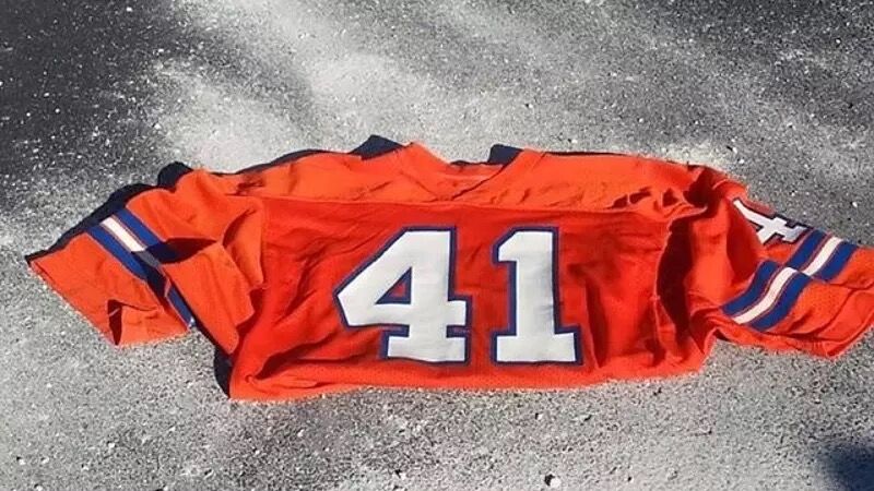 The jersey of Broncos running back Rob Lytle placed on his ashes at a ceremony on Oct. 19, 2014, in a parking lot at Empower Field at Mile High, where Mile High Stadium used to stand. Family members placed the ashes of Lytle, who died in 2010, on the site of a controversial non-fumble by the running back in the 1977 AFC championship game against the Oakland Raiders. (Courtesy of Kelly Lytle) (Kelly Lytle)