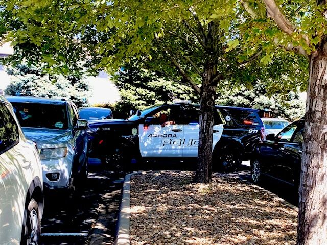 Aurora police cars on extra security duty waited in the parking lot and along the curbs as the celebration of life continued into the afternoon of Sept. 9, 2023. (Carol McKInley/Denver Gazette)