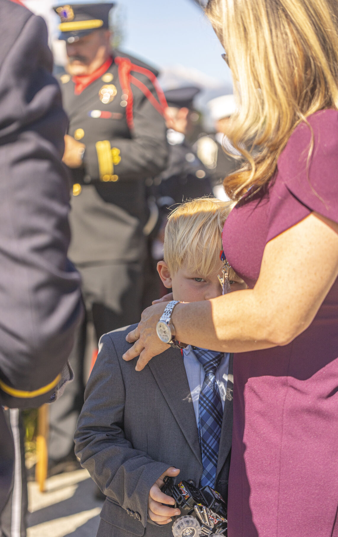 Cayden Viviano, 6, is consoled by his mother Laura Viviano of New York, New York before the start of the Fallen Fire Fighter Memorial 2023 Observance in Memorial Park on Saturday, September 16, 2023. Cayden’s father Christopher Viviano died after a long struggle with a lung disease that developed after working on 9/11 combined with contracting COVID-19. (Gabi Broekema)