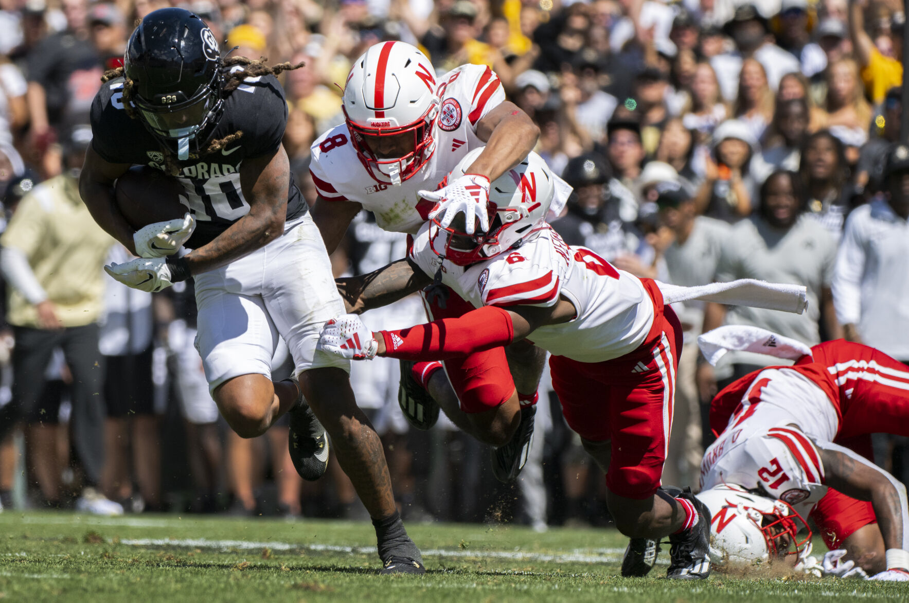 Colorado Buffaloes wide receiver Xavier Weaver (10) runs past Nebraska defensive backs DeShon Singleton (8) and Quinton Newsome for a first down during the second half Saturday, Sept. 9, 2023, at Folsom Field in Boulder, Colo. (The Gazette, Christian Murdock) (Christian Murdock/The Gazette)