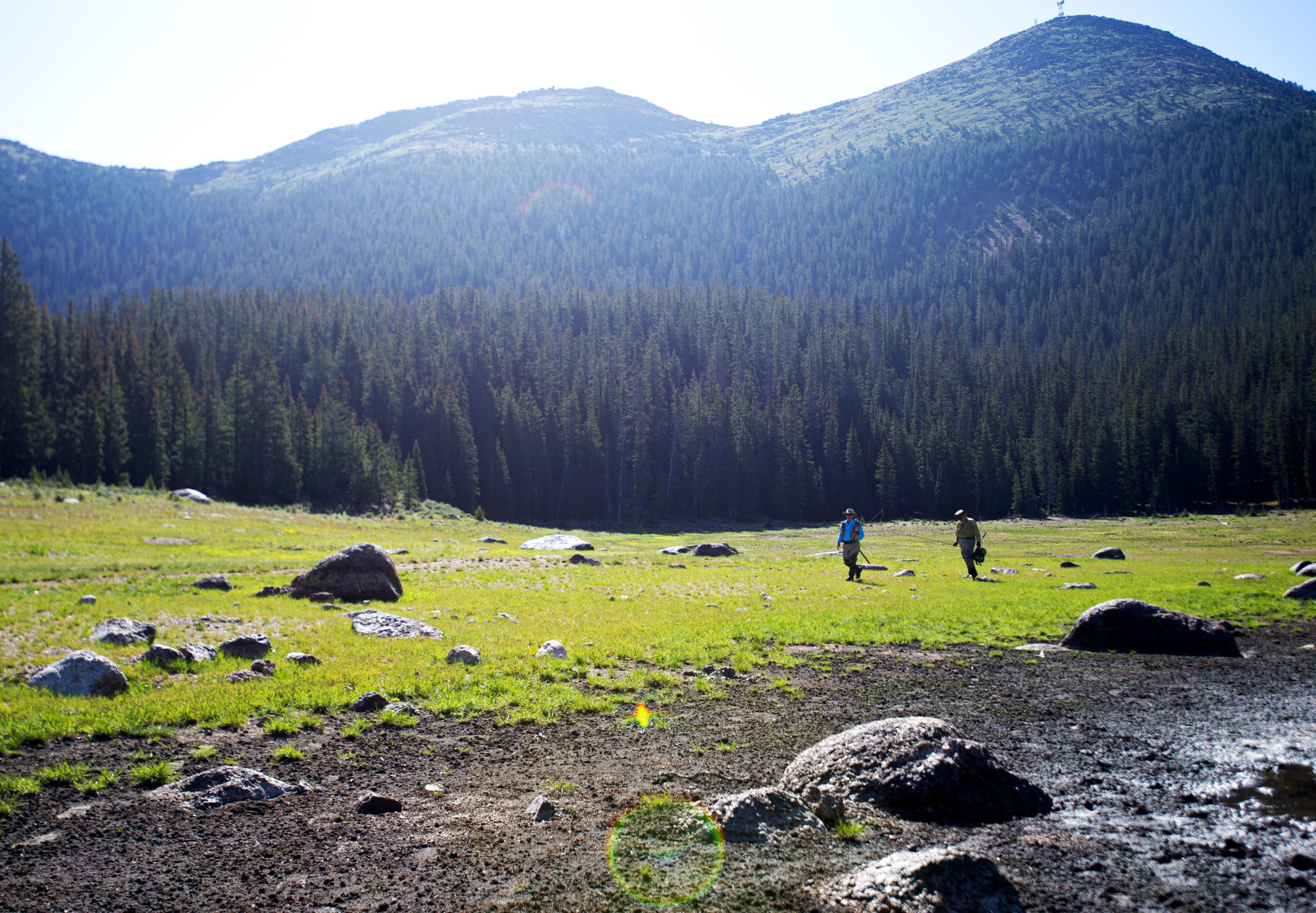 Mike Delaney, left, and Gordy Rothoff walk around the McReynolds Reservoir to fish a new area in July 2019 at the South Slope Recreation Area. (Parker Seibold, The Gazette)