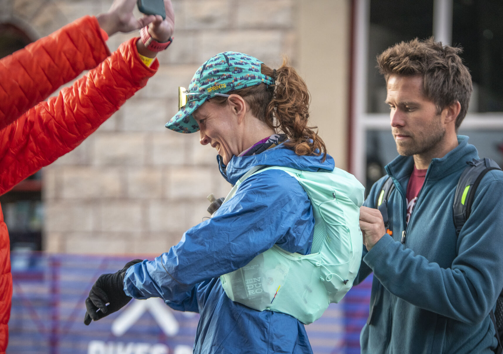 Pikes Peak Marathon finisher Blaire Bingham smiles as her boyfriend Travis Gaylik helps her prep at the start of the race in Manitou Springs on Sunday, September 17, 2023. (Gabi Broekema)