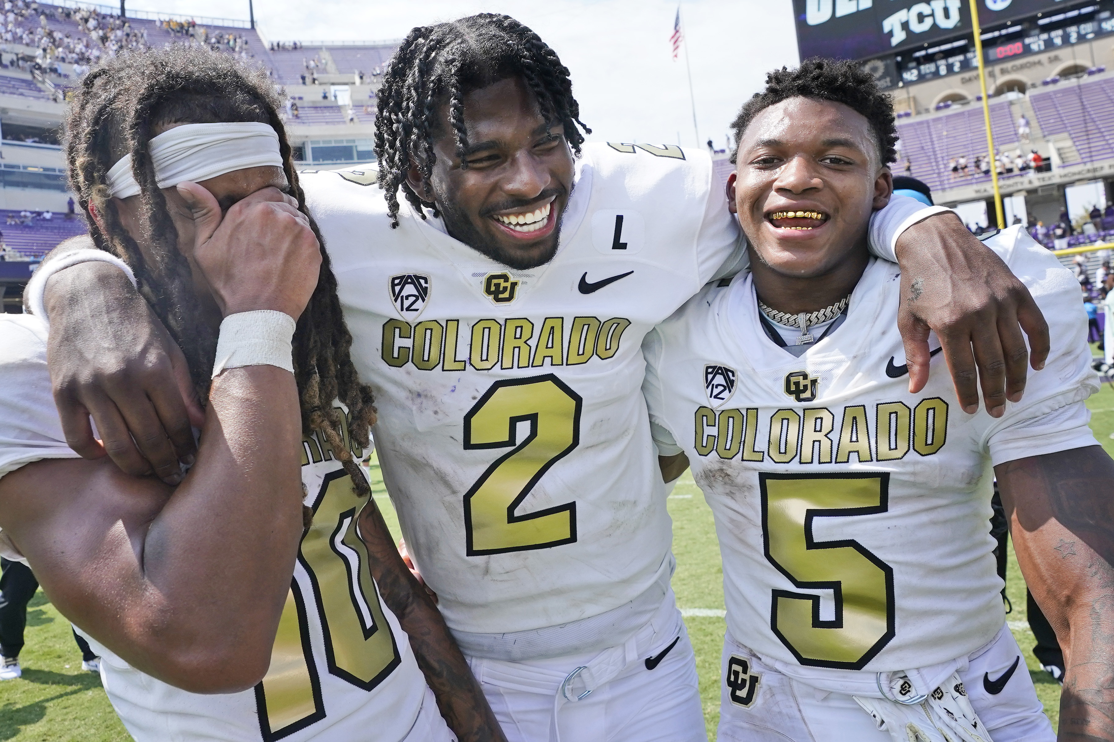 Colorado quarterback Shedeur Sanders (2) embraces wide receivers Xavier Weaver (10) and Jimmy Horn Jr. (5) after an NCAA college football game Saturday, Sept. 2, 2023, in Fort Worth, Texas. (AP Photo/LM Otero) (LM Otero)