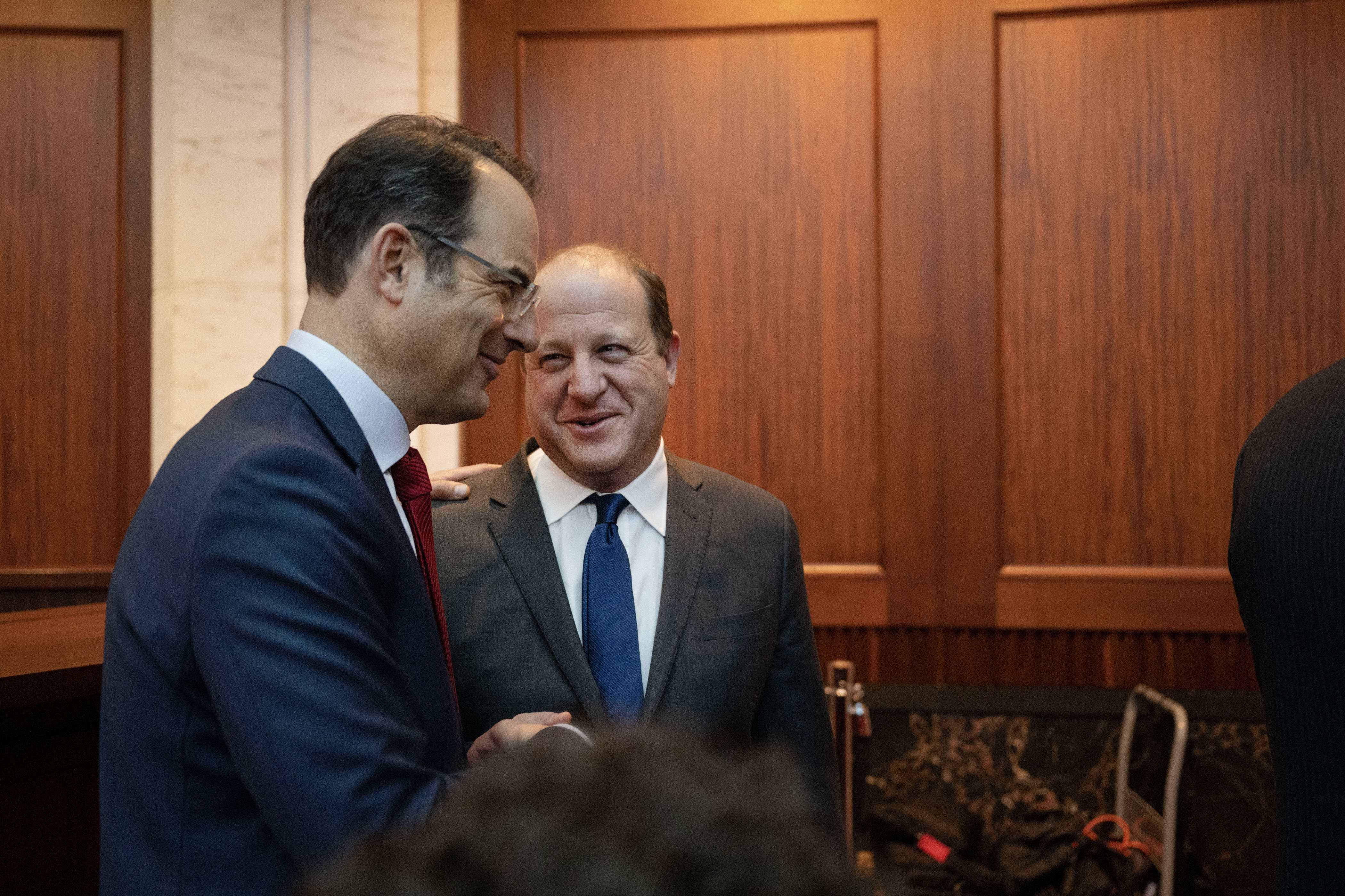 Gov. Jared Polis and Attorney General Phil Weiser greet each other during the investiture ceremony for Weiser’s second term in the Colorado Supreme Court chambers on Thursday, Jan. 12, 2023, in Denver, Colo.(Timothy Hurst/The Gazette) (TimHursttim.hurst@gazette.comhttps://secure.gravatar.com/avatar/aca82bd62b4ee425c598527cd6faa1b1?d=mm&r=g)