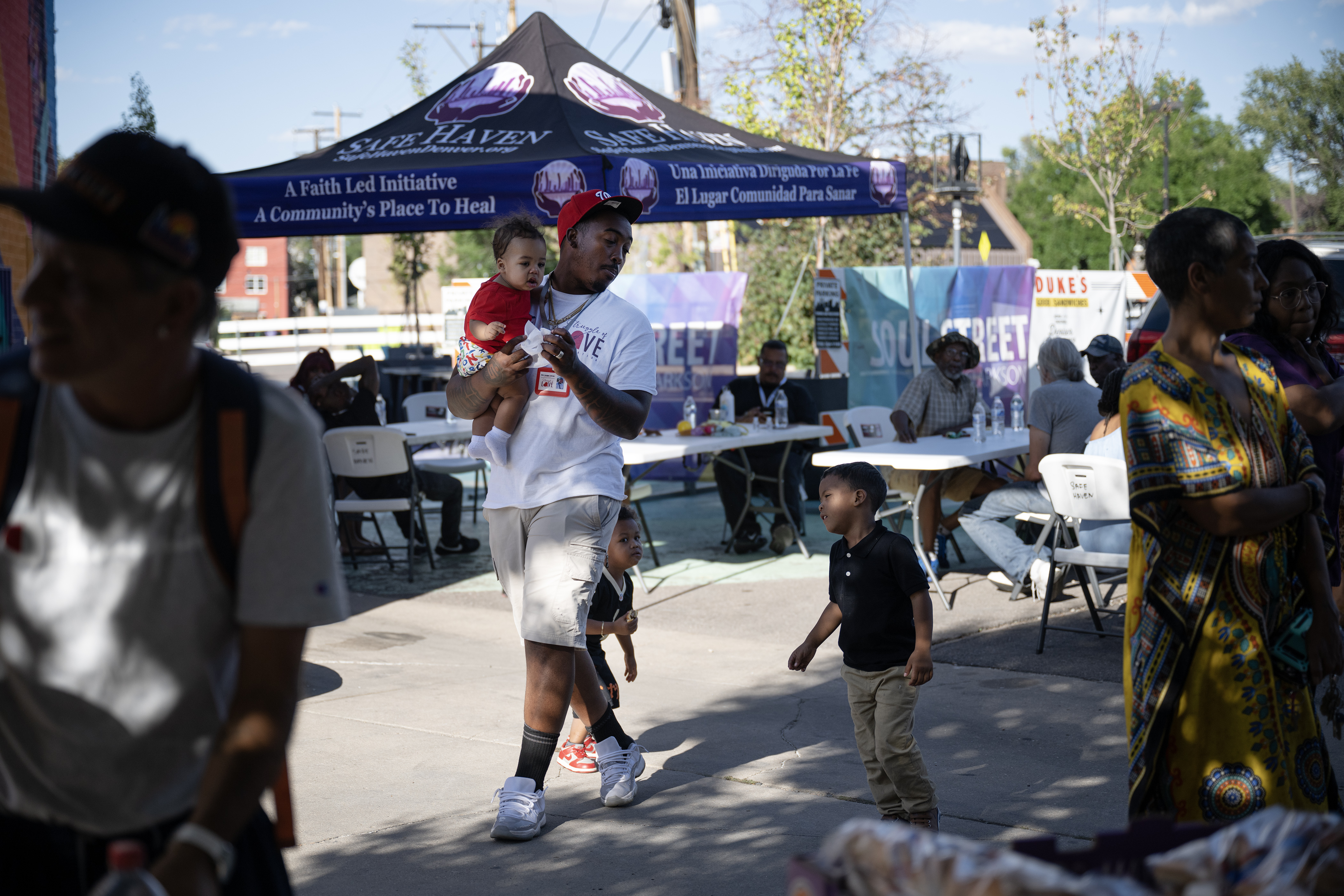 Struggle of Love Foundation program director Elon Hodge walks with his three children, Elon Jr., Apollo and Kemera to a cooler to grab waters during a “Safe Haven Activation” in response to a shooting double-homicide on Aug. 19 as seen on Thursday, Aug. 31, 2023, at Five Points Plaza in Denver. (Timothy Hurst/Denver Gazette) (TimHursttim.hurst@gazette.comhttps://secure.gravatar.com/avatar/aca82bd62b4ee425c598527cd6faa1b1?d=mm&r=g)