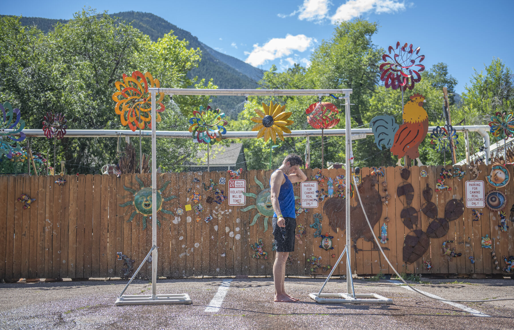Pikes Peak Marathon finisher takes advantage of the temporary showers in Manitou Springs on Sunday, September 17, 2023. (Gabi Broekema)