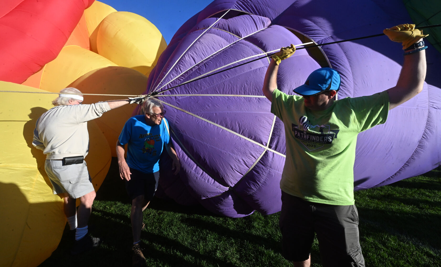 Peg Leg Pete the Pirate Parrot balloon and pilot Dave Reineke are two of the new kids on the block for this year’s Colorado Springs Labor Day Lift Off. Pilot Reineke (center) checks the sides of the balloon as volunteers hold it during the cold inflate on Sunday, Sept. 3, 2023. The balloons didn’t lift off on Sunday morning, because of winds at higher altitudes, but most still participated with a stationary inflation to please the thousands. (Jerilee Bennett, The Gazette)