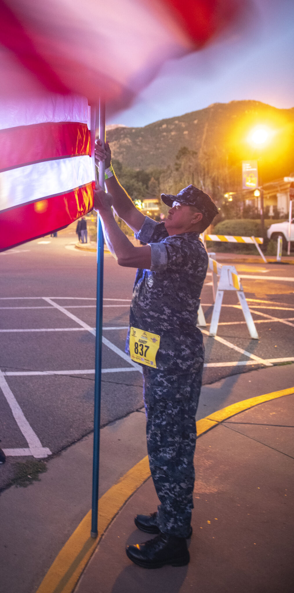 Pikes Peak Marathon runner Randy Woodward of Nashville, Tn., prepares to carry the American flag up America’s Mountain in Manitou Springs on Sunday, September 17, 2023. (Gabi Broekema)