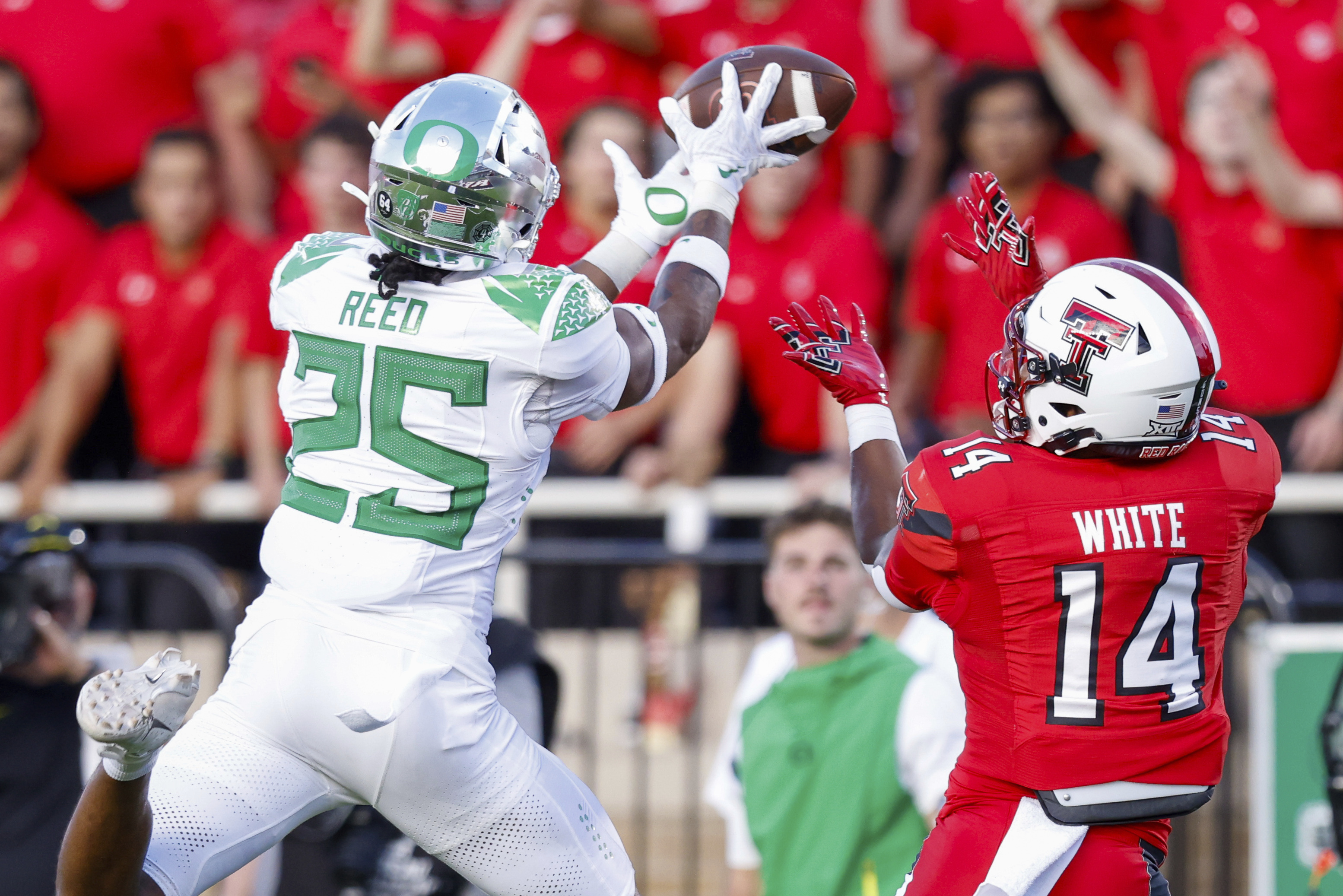 Oregon defensive back Nikko Reed (25) breaks up a pass intended for Texas Tech wide receiver Xavier White (14) during the first half of an NCAA college football game, Saturday, Sept. 9, 2023, in Lubbock, Texas. (AP Photo/Chase Seabolt) (Chase Seabolt)