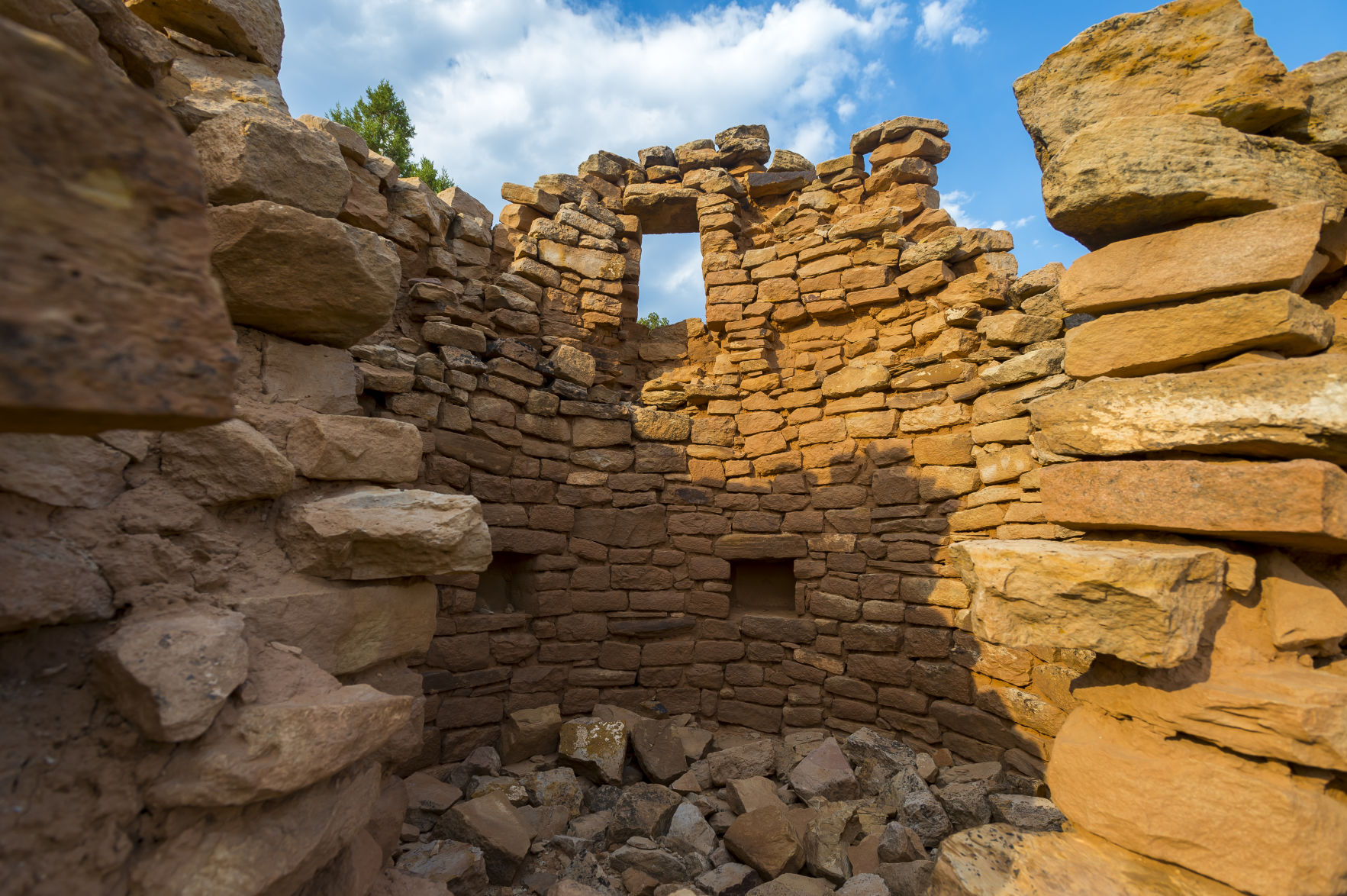The inside of the main tower at the Painted Hand Pueblo at Canyons of the Ancients National Monument on Thursday June 21, 2017 in Cortez, Colorado. The main tower is built upon a large outcrop of rock and it also had a dwelling beneath it. The stones that were once part of the tower and its lower room are strewn all around the boulder. (Photo by Dougal Brownlie, The Gazette). (Canyons of the Ancients National Monument. Dougal Brownlie)