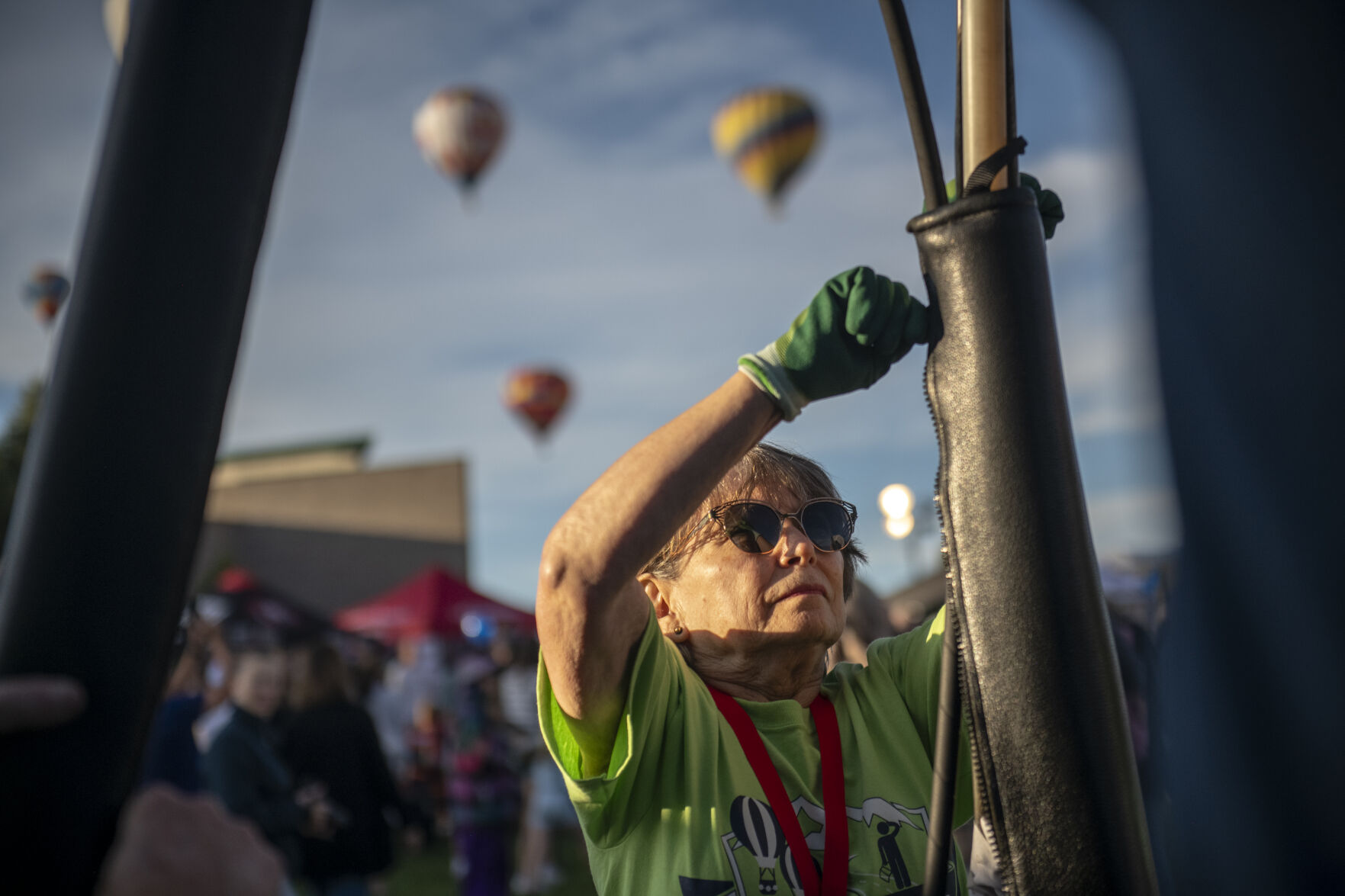 Labor Day Lift off volunteer Carol Mossa helps set up the Synchronicity balloons in Memorial Park in Colorado Springs on Saturday, September 2, 2023. (Gabi Broekema, The Gazette) (Gabi Broekema)