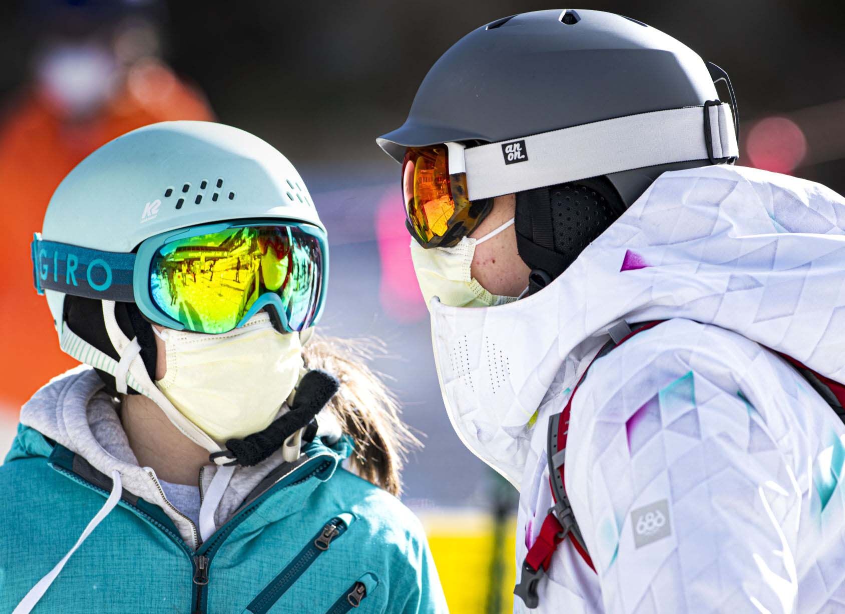 FILE PHOTO: Ella Anderson, 12, left, and Finley Anderson, 14, of Evergreen, wear their masks as they wait in line for first chair at Arapahoe Basin on May 27, 2020, the first day back skiing at Colorado ski area since the state closed all areas in March because of the COVID-19 pandemic. (Christian Murdock, The Gazette)