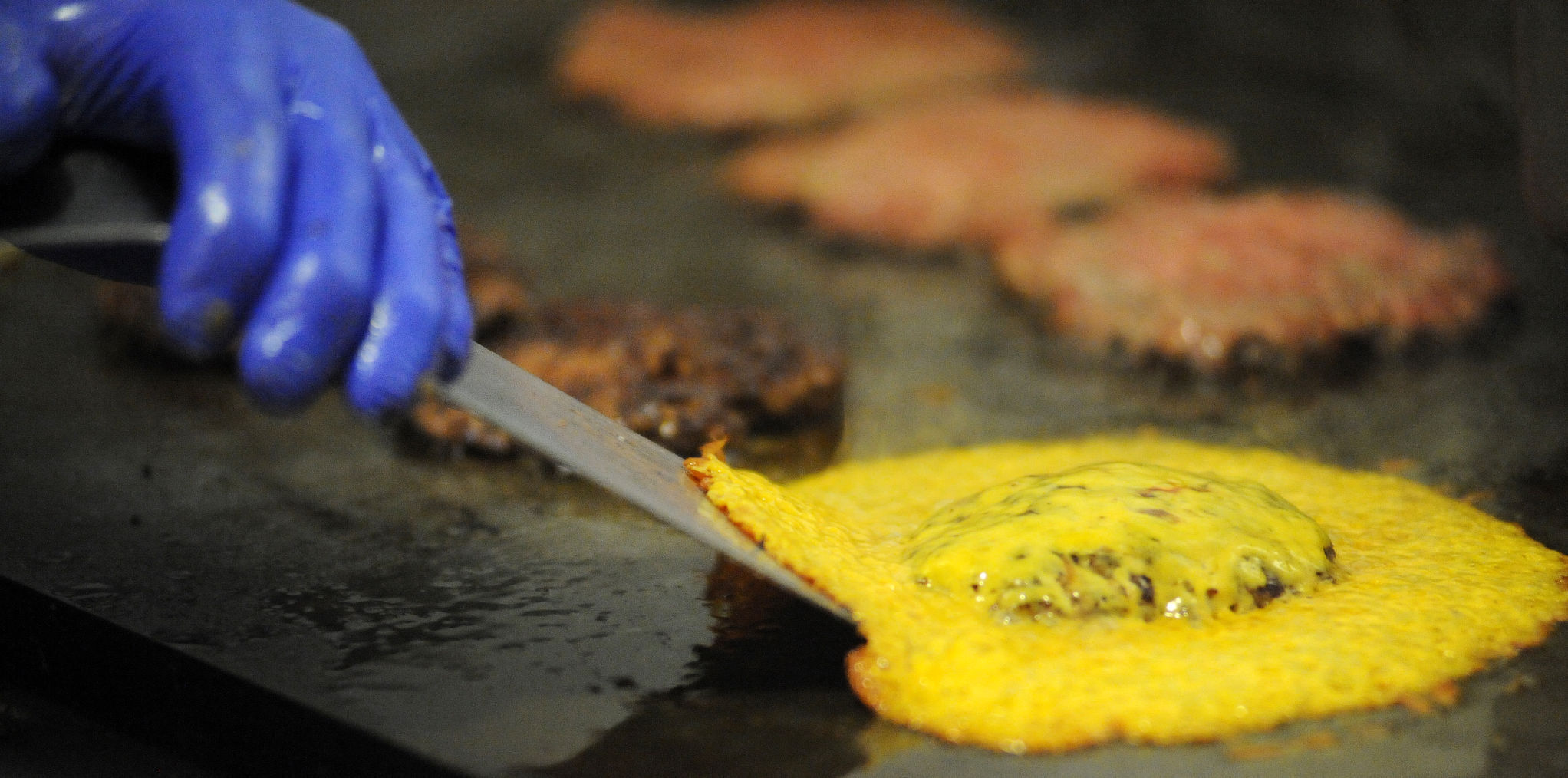 Cheese overflows the Skirted Heifer burger in Colorado Springs. (Jeff Kearney, The Gazette)