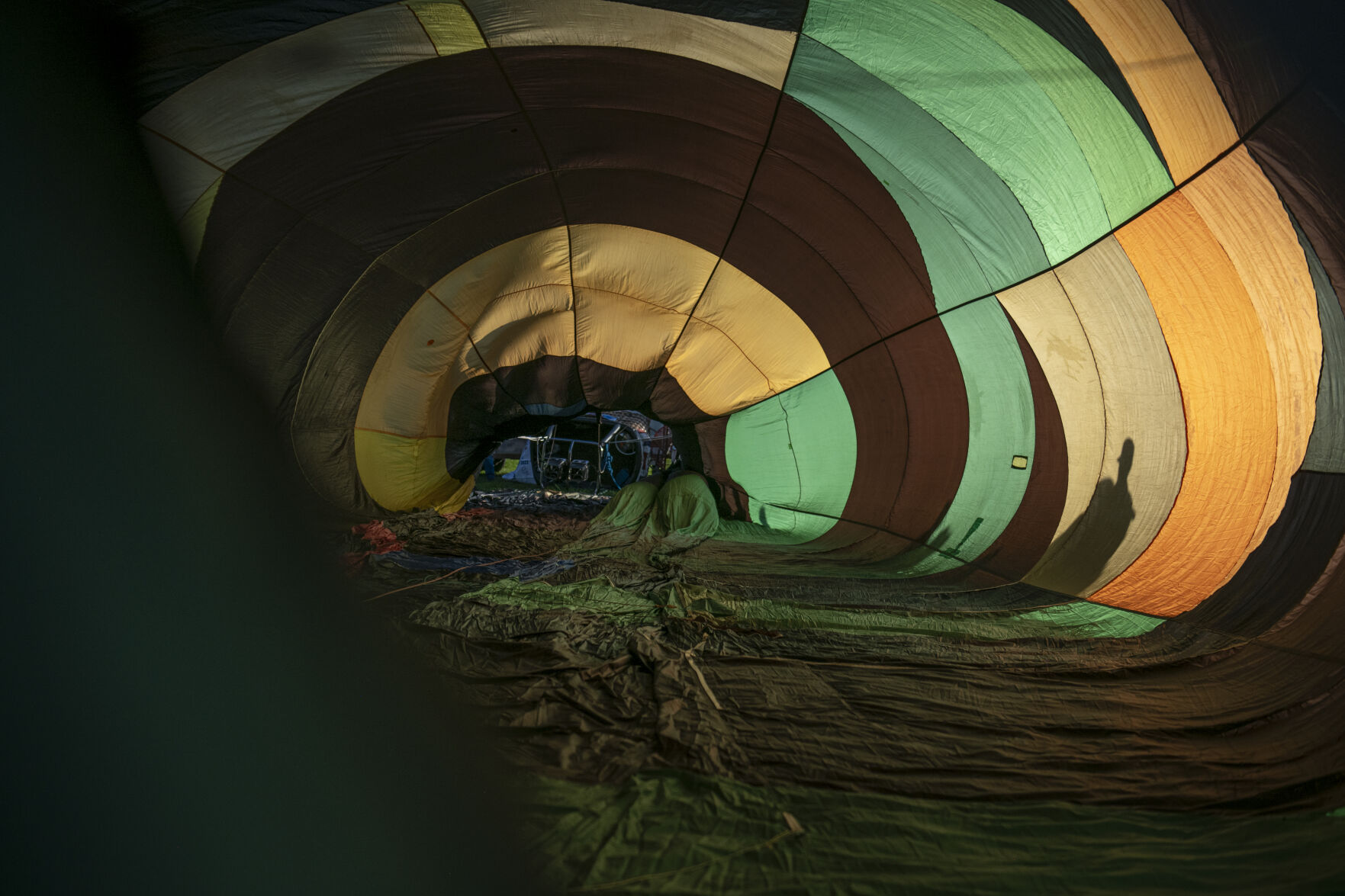 Jeff Haliczer looks over his balloon Synchronicity alongside volunteer balloon chasers in Memorial Park for the Labor Day Lift Off in Colorado Springs on Saturday, September 2, 2023. (Gabi Broekema)