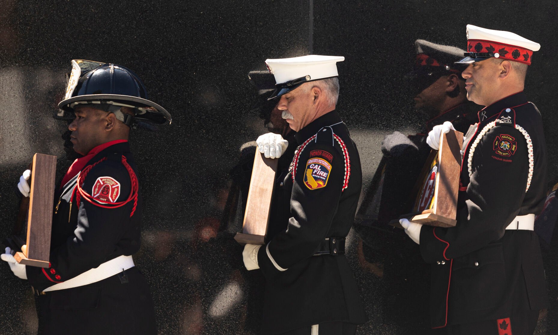 Firefighter bear flags for their fallen comrades during the Fallen Fire Fighter Memorial 2023 Observance in Memorial Park on Saturday, September 16, 2023. (Gabi Broekema)