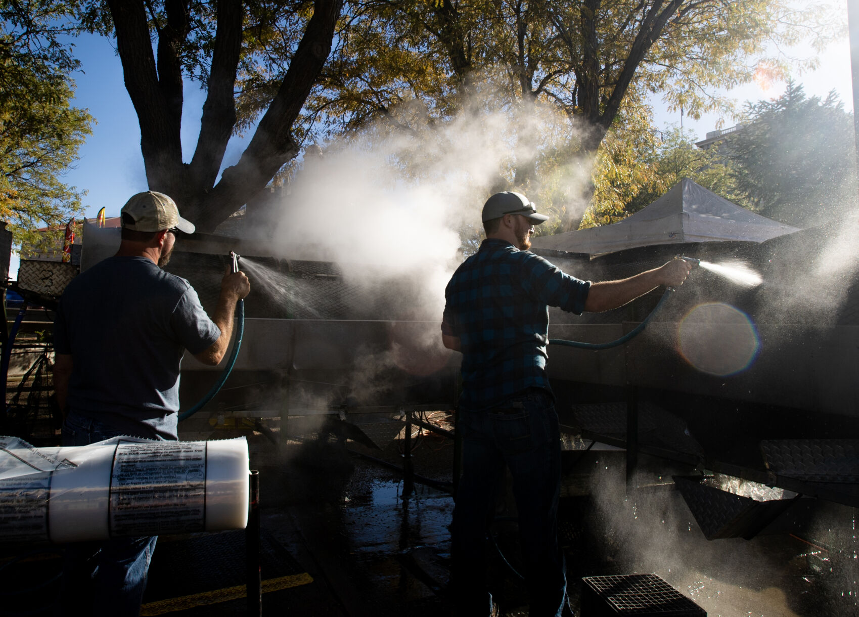 Auston Yorke sprays down a batch of chiles in a roaster on the first day of the 29th Annual Pueblo Chile and Frijoles Festival in Pueblo, Colo., on Friday, Sept. 22, 2023. The festival continues on Saturday from 10 a.m. to 12 a.m. and Sunday from 10 a.m. to 5 p.m. (Parker Seibold, The Gazette) (Parker Seibold)