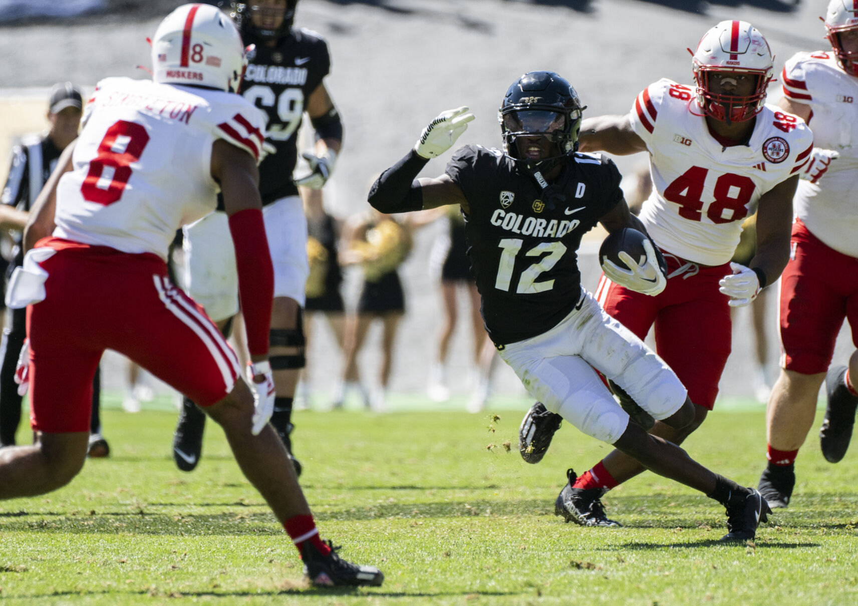 Colorado Buffaloes wide receiver Travis Hunter (12) runs down field against Nebraska defensive back DeShon Singleton and linebacker MJ Sherman (48) during the first half Saturday, Sept. 9, 2023, at Folsom Field in Boulder, Colo. (The Gazette, Christian Murdock) (Christian Murdock/The Gazette)