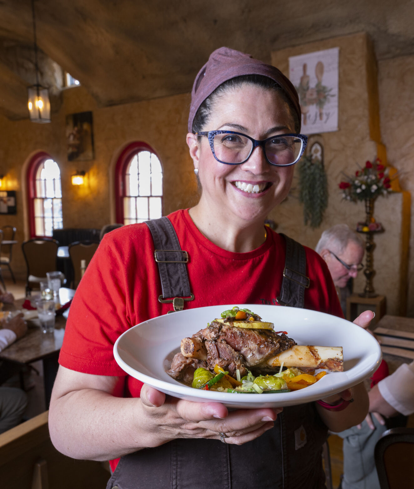Chef and owner Denise Vigil holds a plate of the braised lamb shank at Friar’s Fork Tuesday, Aug. 1, 2023, in Alamosa, Colo. The James Beard Foundation — the culinary Oscars — named Friar’s Fork a semifinalist for America’s best new restaurant. (The Gazette, Christian Murdock) (Christian Murdock/The Gazette)
