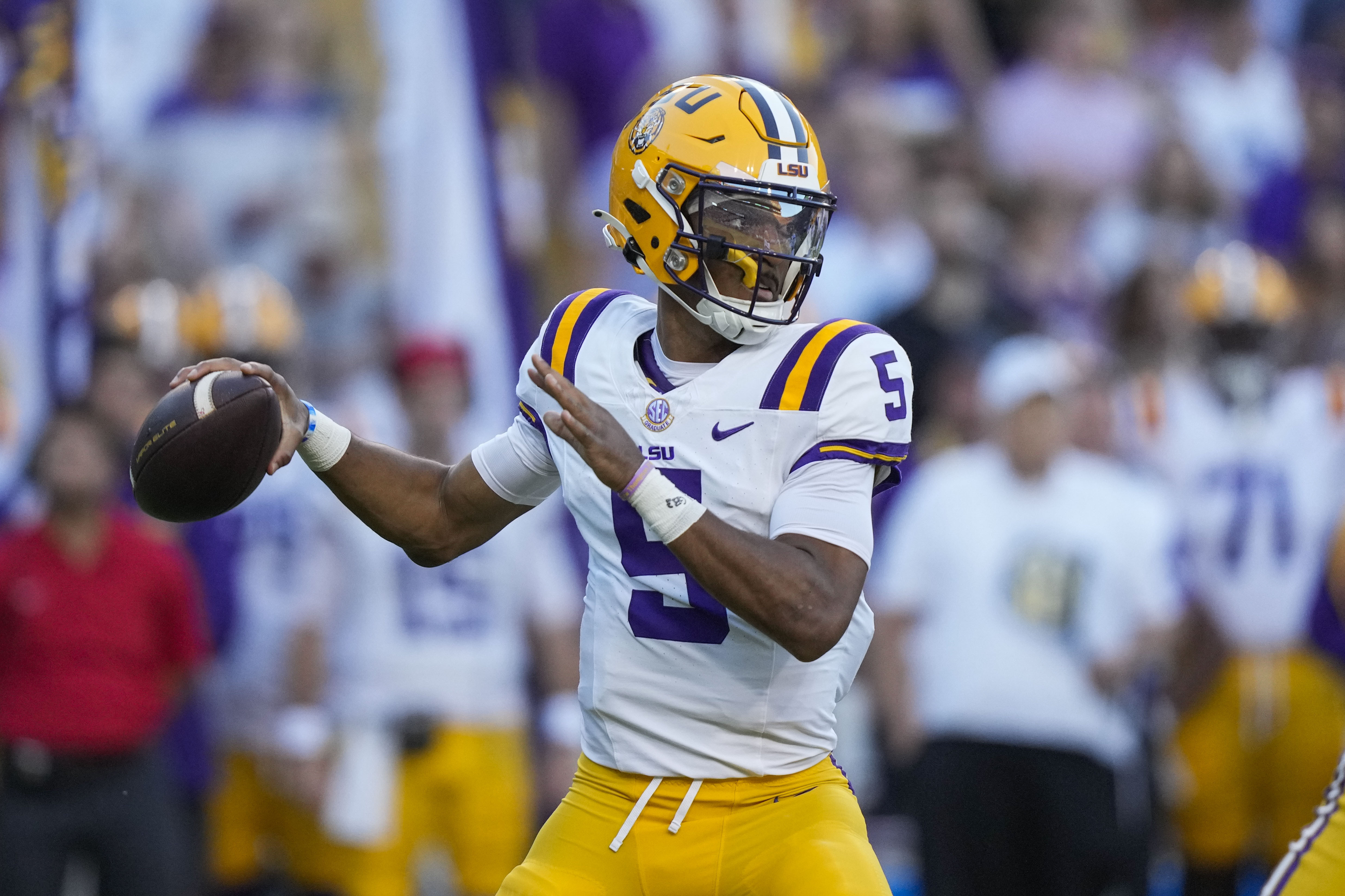 LSU quarterback Jayden Daniels (5) drops back to pass in the first half of an NCAA college football game against Auburn in Baton Rouge, La., Saturday, Oct. 14, 2023. (AP Photo/Gerald Herbert) (Gerald Herbert)