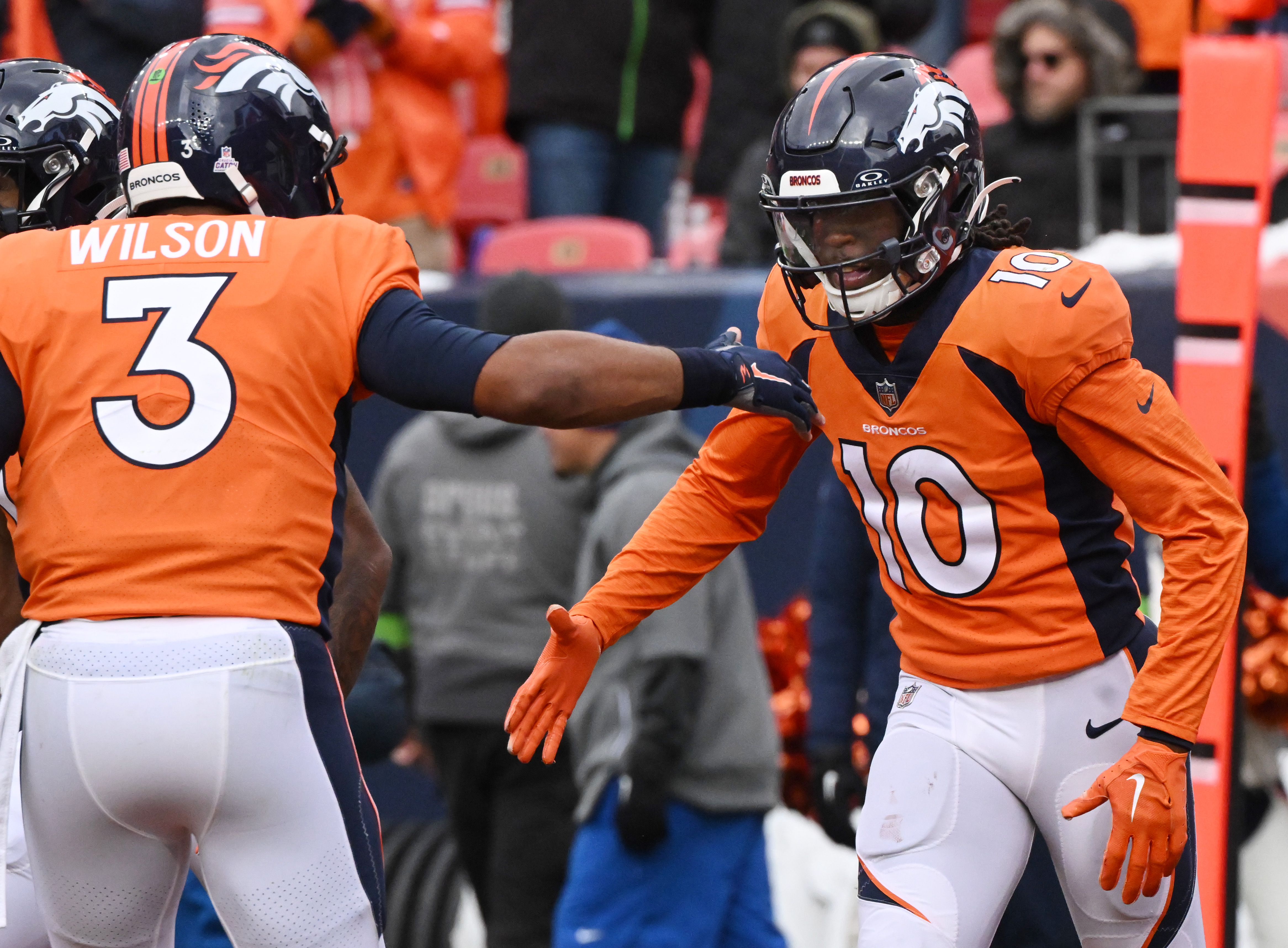 Denver Broncos wide receiver Jerry Jeudy (10) gets congratiions from Denver Broncos quarterback Russell Wilson (3) after getting his first touchdown of the year during a game at Empower Field at Mile High on Sunday, Oct. 29, 2023. The Broncos won the game 24-9. (Photo by Jerilee Bennett, The Gazette)