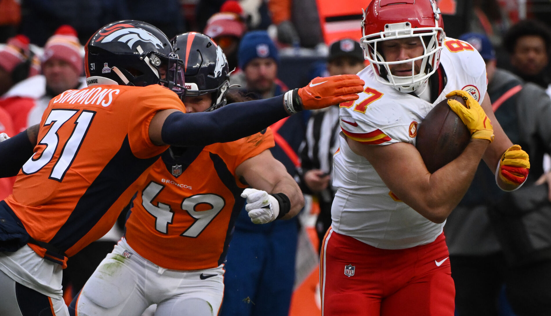 Denver Broncos safety Justin Simmons (31) and linebacker Alex Singleton (49) go after Kansas City Chiefs tight end Travis Kelce (87) in the third quarter at Empower Field at Mile High in Denver on Oct. 29. The Broncos beat the Chiefs 24-9, snapping a 16-game skid against Kansas City. (JERILEE BENNETT, THE GAZETTE)