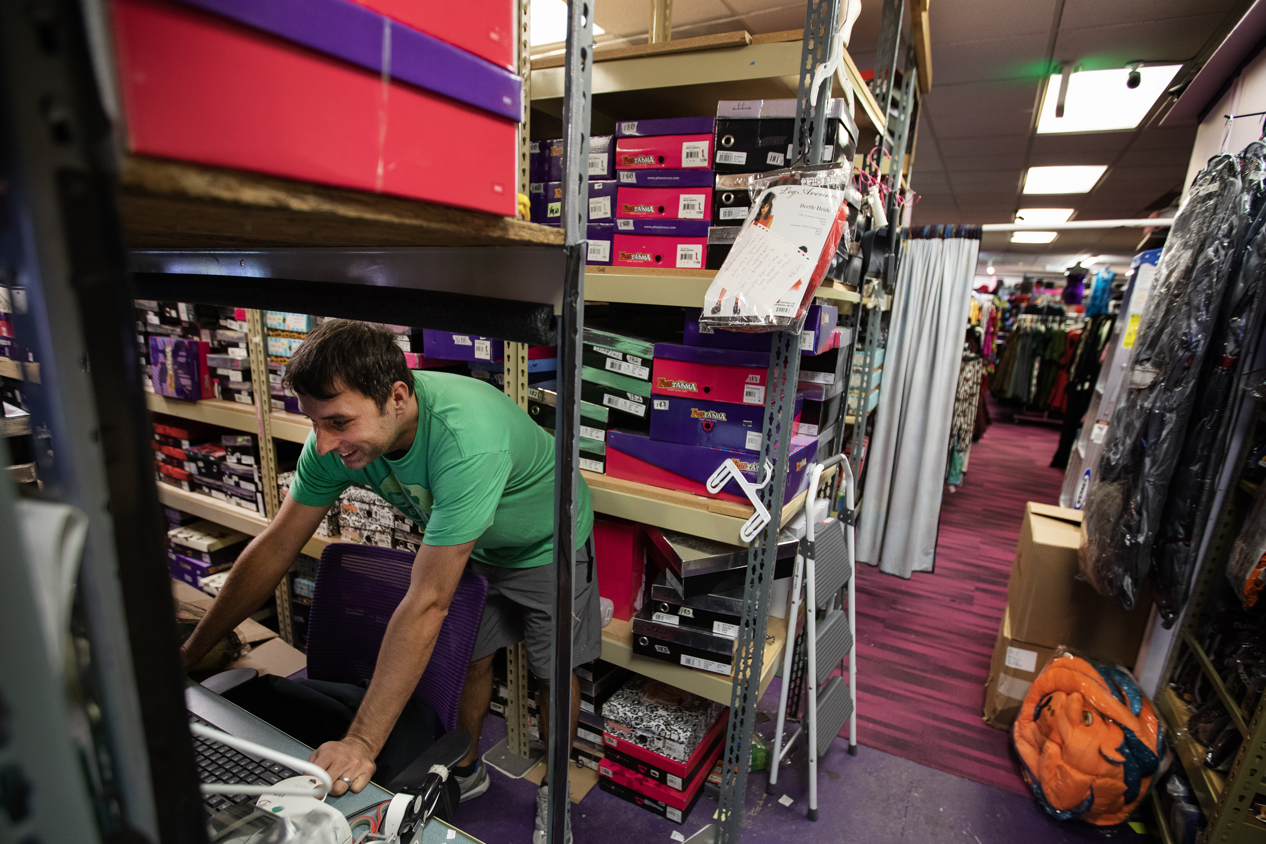 Owner Todd Belanger leans over a computer in the store’s costume overstock warehouse at Disguises A Costume Superstore on Friday, Oct. 6, 2023, in Lakewood, Colo. (Timothy Hurst/Denver Gazette) (Timothy Hurst/Denver Gazette)