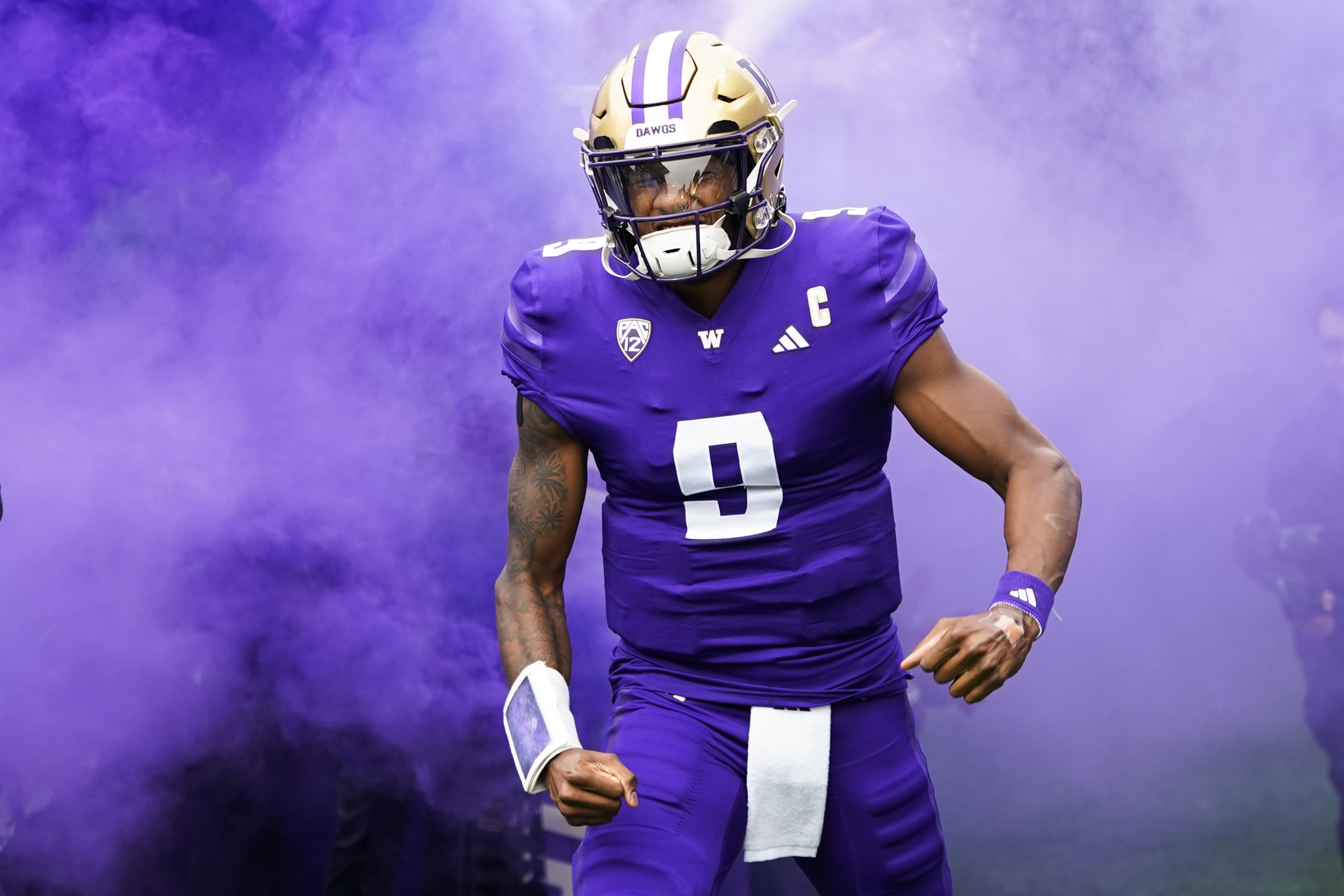 Washington quarterback Michael Penix Jr. runs out to the field through purple smoke before an NCAA college football game against Oregon, Saturday, Oct. 14, 2023, in Seattle. (AP Photo/Lindsey Wasson) (Lindsey Wasson)