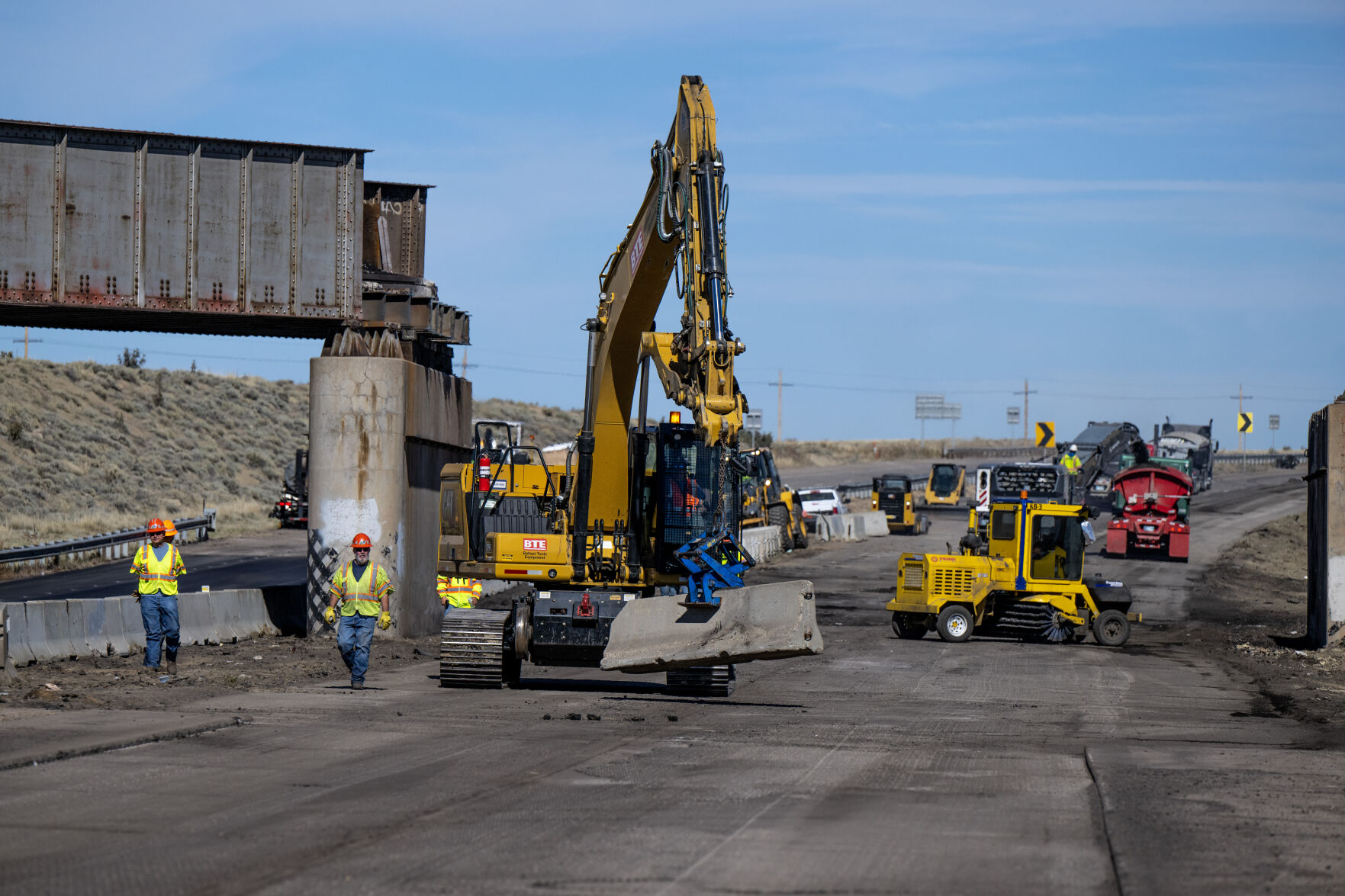 Workers repair Interstate 25 northbound Wednesday, Oct. 18, 2023, north of Pueblo, Colo. Interstate 25 has been closed since a trail derailed Sunday, spilling railcars and coal and forcing officials to close the highway. The southbound lanes are now open and Colorado Gov. Jared Polis said that northbound lanes will be navigable some time on Thursday. (Parker Seibold, The Gazette) (Parker Seibold)