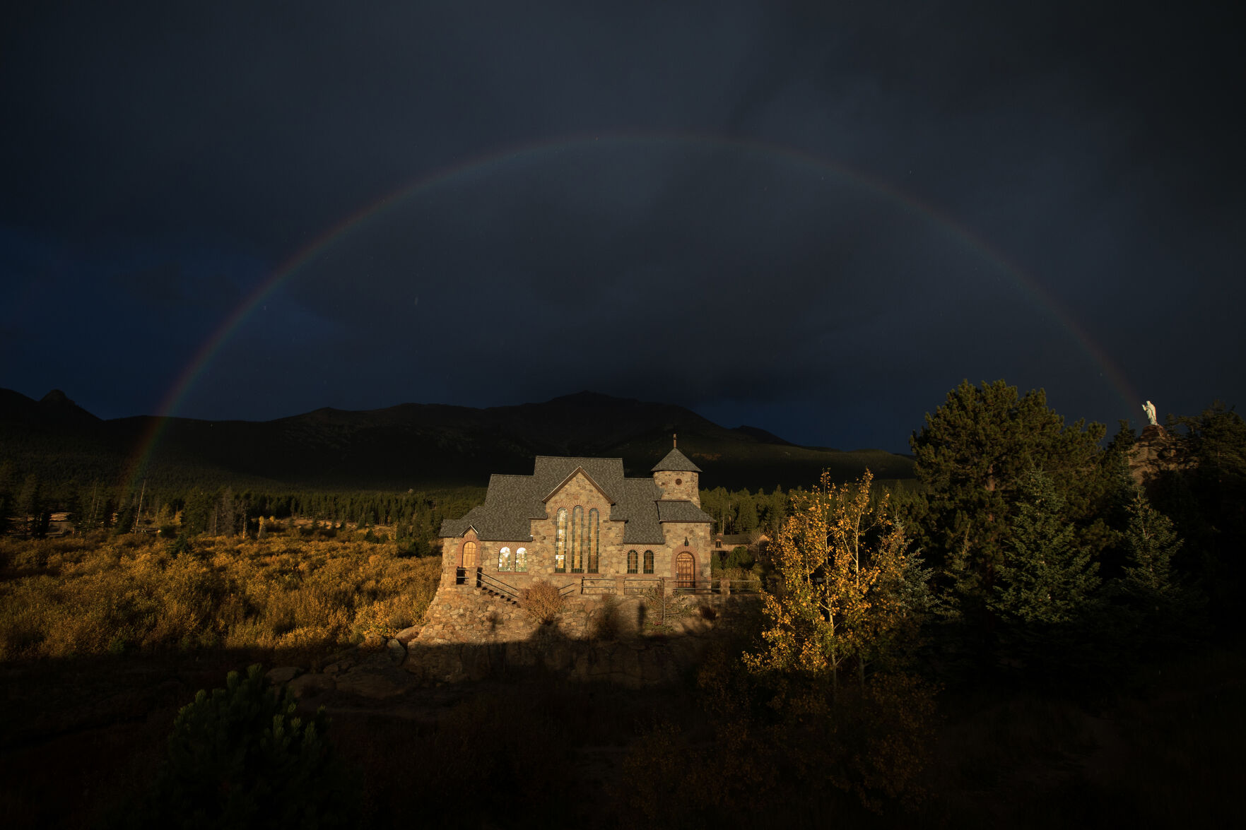 A rainbow arches over Saint Catherine's Chapel on the Rock as the church is illuminated by the early morning sun on Monday, Oct. 2, 2023, in Allenspark, Colo. (Timothy Hurst/Denver Gazette) (TimHursttim.hurst@gazette.comhttps://secure.gravatar.com/avatar/aca82bd62b4ee425c598527cd6faa1b1?d=mm&r=g)