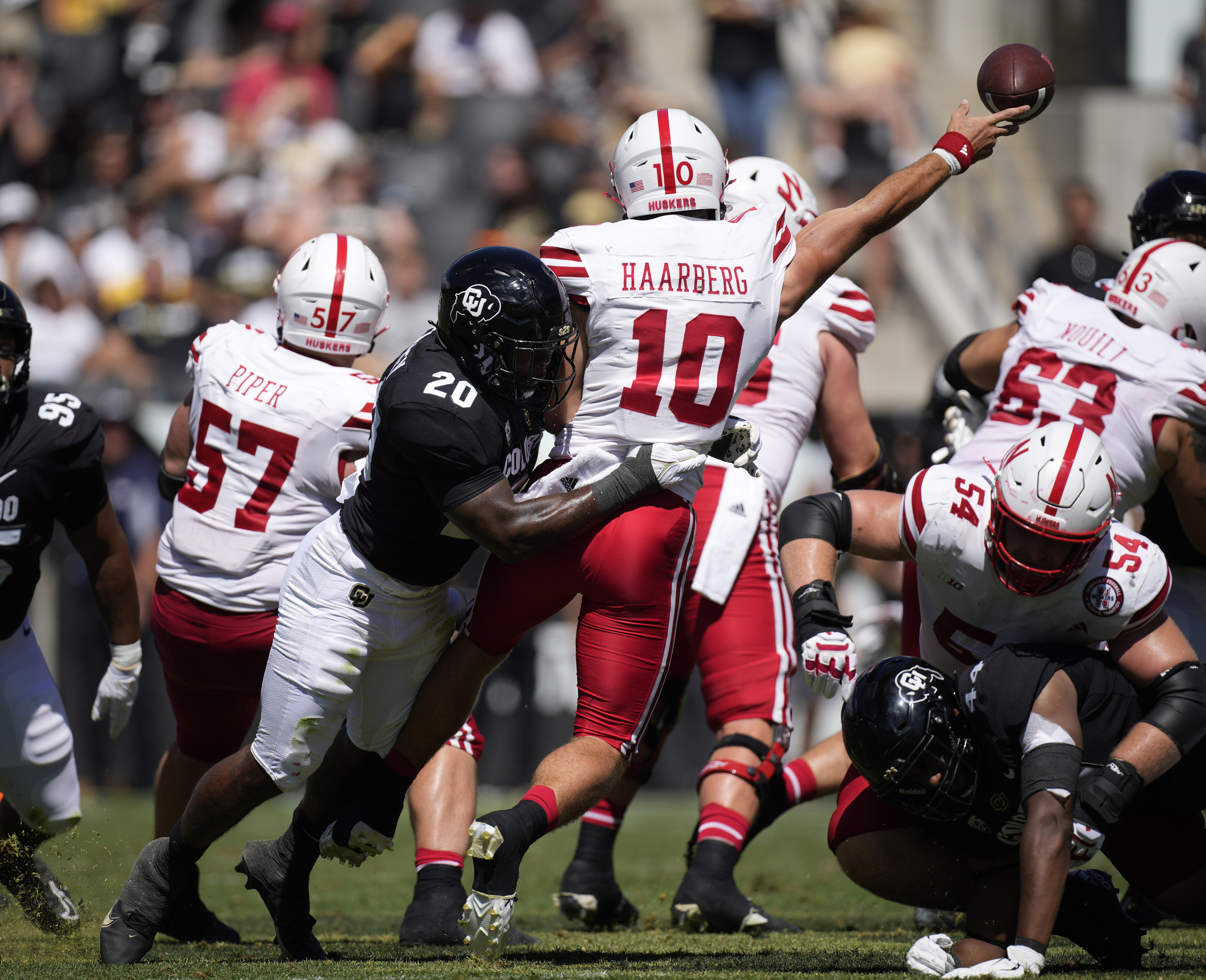 Colorado linebacker LaVonta Bentley, left, hits Nebraska quarterback Heinrich Haarberg as he passes the ball in the second half of an NCAA college football game Saturday, Sept. 9, 2023, in Boulder, Colo. (AP Photo/David Zalubowski) (David Zalubowski)
